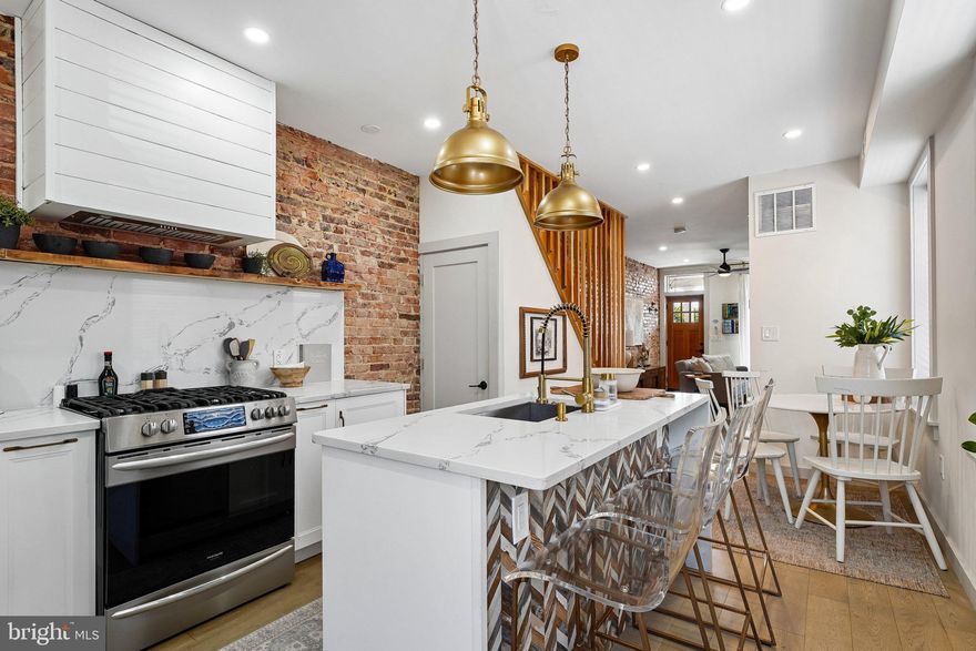 End-of-group. Fully renovated. A rare blend of lifestyle and income potential in the heart of Remington. This 3-bedroom, 3.5-bath rowhome offers 1,040+ sq ft above grade plus a fully finished lower level, designed to live larger, brighter, and more functionally than typical city homes. The sun-filled main level features hardwood floors, an open layout, and a standout kitchen with white cabinetry, granite countertops, stainless steel appliances, and a center island, flowing into a stylish living space anchored by a fireplace and exposed brick that adds warmth and character. The layout naturally extends to a fully staged private patio—complete with seating, lighting, grilling space, and greenery—creating a true indoor-outdoor experience ideal for everyday living or entertaining. Upstairs, three well-sized bedrooms and updated baths with modern tile and fixtures provide comfort and privacy, while the finished lower level offers a second living zone, game room, storage, and rear entry—perfect for guests, flexible living, or separation of space.

Currently operating as a successful Airbnb/short-term rental, the home delivers strong performance at approximately $290/night and around $3,000/month with steady occupancy, and is available fully furnished for a true turnkey setup or can be delivered vacant depending on buyer preference. The combination of 3.5 baths, multiple living areas, dedicated workspace potential, and seamless layout makes it ideal for hosting, house hacking, or primary living with income flexibility. Located minutes from Johns Hopkins, R. House, and the Hampden corridor, with strong walkability to dining and retail, this property offers both immediate livability and proven earning power in one of Baltimore’s most active and desirable neighborhoods. Buyer to verify short-term rental licensing and use.