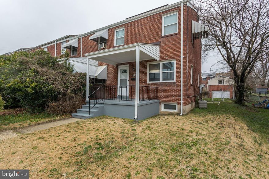 This is a great updated end of group 2 BR all brick townhouse, recent roof, updated furnace and windows, with a full bath upstairs.  Enjoy the large covered front porch, opening to a wide living room, separate dining room with updated lighting, and kitchen with access to the back yard for easy entertaining.  The top two levels both have wood laminate floors.  There's a separate Family Room in the basement, for extra living space, plus a large utility room with washer and dryer, with lots of room for storage.  The basement has an outside walk up entrance to the fenced back yard as well as a 2 car parking pad in the rear.  The solar panels on the NEW roof are owned, and convey with the property - no leasing to be concerned about, and lower electric bills!  Close to Medstar Health and Morgan State University - Easy commuting location!  Don't wait - this one won't last!