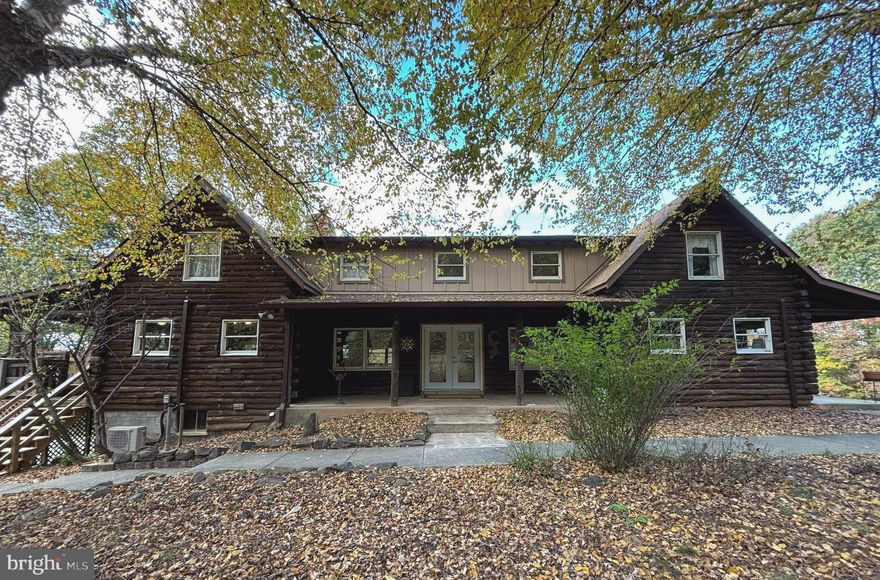Inviting Log Home exudes rustic charm; is also deceptively spacious w/endless possibilities! Retreat home has been carefully reclaimed with many renovations, until a family opportunity interrupted. Not only does the home offer generous space for au pair or generational en-suite - separate side entrance with own private porch, main level separate living space, bed and remodeled bath, but the unfinished basement w/rough-in offers more possibility. 3 Level Fireplace with 4 flues - dual Kitchen/Den fireplace converted to gas. Upper level 3 Bedrooms 2 Full baths, cathedral ceilings, tons of charm & interesting detail. Outbuilding garage - connected by picturesque walkway from Kitchen/side porch - has a newly finished studio with loft space, catwalk and storage room. Below is main level parking for 3 vehicles, and lowest rear level entry garage has what was once a car enthusiast's shop work-space. Ideal for own home business or plenty of space for hobbies! Hike the Appalachian Trail, trek to historic Harpers Ferry or raft the local rivers - many enjoyable small towns, Civil War sites, breweries & wineries surround. Large yard, treed views, privacy, natural abundance - this home has so much to offer. You won't want to miss it!