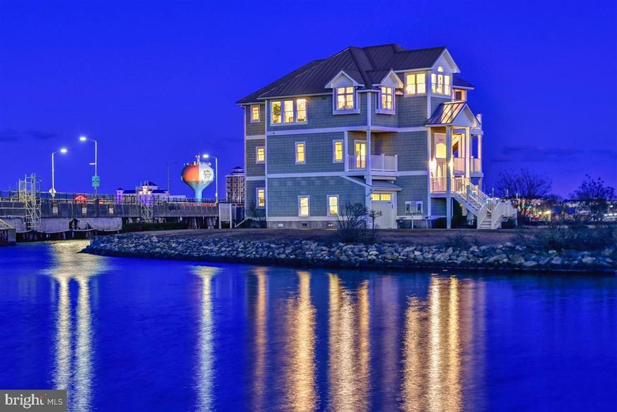 Exquisite waterfront custom estate with 5BR/4.5 BA in "The Estates of Inlet Isle" hits the market, and there is deep water and room for a 42 foot boat.  Immerse yourself in the ambiance of this luxurious waterfront lifestyle that features exceptional craftsmanship, astute attention to detail and extensive custom finishes. This home is located in West Ocean City close to the beach, boardwalk, restaurants, shopping and the inlet. The home was designer decorated and is being sold fully furnished for your immediate enjoyment.  The floor plan is perfect for large families and for entertaining guests.  The professional kitchen is a chef's dream with high end stainless steel appliances, tile backsplash, quartz countertops, upgraded lighting and breakfast bar.  The large dining area is off the kitchen for enjoying dinner with family and friends. The spacious great room flows off the kitchen and has a fireplace with custom waterfall.  Sit back and enjoy a glass of wine or a cocktail from the wine cooler or wet bar.   Enjoy cool summer breezes from the deck as you watch the sun rise.  The master bedroom and lavish master bath are also on the main level, as is the office area that overlooks the marina.  On the lower level there is a  separate bedroom, a large second living area and full custom bath.  This could be used as an in-law suite or lavish guest room.  On the second level there are three  additional bedrooms and two more full baths.  There are multiple decks and a screened in porch for relaxing.  The house also has a garage, a lawn sprinkler system, a elevator upgraded lighting, upgraded ceiling fans, custom tile work, maintenance free decking and a nice yard.  This home is in the perfect location to watch the fireworks at the inlet and to watch the boats and yachts in the inlet and marina.  Come take a look before this incredible home is Sold!