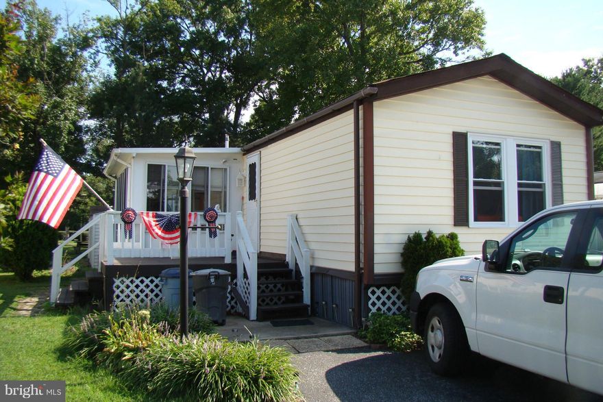 Lovely home in Williams Estates, backs to open field.  The open floor plan gives you a bedroom and full bath on each end, large living room with pellet stove with a programmable thermostat, and a large kitchen/dining area.  All appliances included.  Three season room for added space.  New windows, new carpeting in living room and master bedroom.  Subject to monthly ground rent and Park Approval.