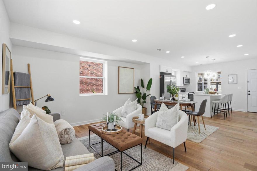 Beautifully renovated and move-in ready 4BR/2.5BA end of row Townhome located on a tree lined street in Brooklyn.  Make your way to the covered front porch, which has a beadboard ceiling and newly installed railings and open the door into your new home.  This home has been transformed into a luxurious home, featuring an open main floor plan, wide plank wood flooring, recessed lighting, glamorous lighting fixtures, high ceilings, a crisp clean color palette, and numerous upgrades.  The main floor boasts a spacious living room, dining room, and stunning kitchen.  The kitchen offers plenty of cabinets, stainless steel appliances, sleek quartz countertops, an undermount sink under a window, and an island with breakfast seating and glamorous pendant lights. Completing the main floor are a half bath and stacked laundry. The newly constructed staircase, featuring a wooden baluster with metal rails, leads to the second floor, which includes a spacious primary bedroom, a sizable secondary bedroom, a smaller third bedroom, and a newly remodeled full bath.  The lower level features additional finished living space offering a full bath with a beautifully tiled walk-in shower, a spacious family room, a room ideal as a home office or guest room, storage, and a walk-out to the fenced yard.  From the kitchen step out onto a large covered patio that leads to a yard filled with tons of possibilities and a detached one-car garage.