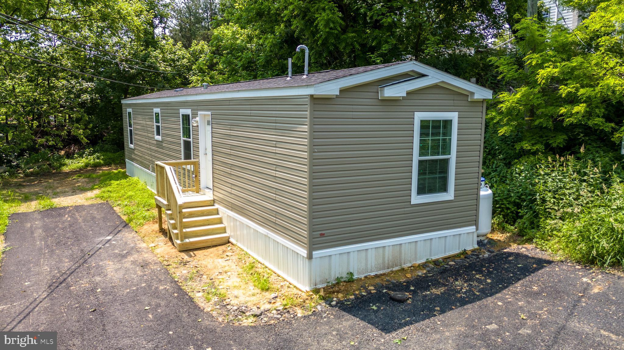 Welcome to this brand-new manufactured home in Royal Manor Village, a peaceful and private residential community of 8 home sites, just 10 minutes from both Bethlehem and Easton, and only 5 minutes from I-78. Set against a backdrop of beautiful long-distance views, this home offers a quiet rural feel with easy access to major routes, shopping, and dining. Nature lovers will enjoy being close to outdoor attractions like the Delaware River and Canal, Fry’s Run Park, and Mariton Wildlife Sanctuary. Featuring Two Bedrooms / Two Baths and 693 sq.ft of thoughtfully designed living space, this move-in ready home combines comfort, efficiency, and modern convenience. The community has been fully updated with a newly paved private road and, offering low-maintenance, living in a scenic setting. Water, sewer, roadway snowplowing, and common area grass cutting is included. Whether you are a first-time buyer, looking to downsize, or simply seeking a peaceful place to call home, this is a great opportunity to enjoy a fresh start in a beautifully finished new home.