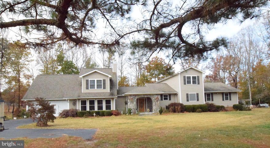 ATTENTION HOBBY FARMERS!!!  Incredibly beautiful kitchen with Stainless Steel Appliances-17 Acres of Land. Large stocked pond. Hardwood in master bedroom. Hardwood in kitchen/formal dining room. Multiple outdoor sheds perfect for wood workin or even old car restoration garage/carports/shelters. Awesome  spacious relaxing Florida room. Enormous back deck complete with an electric Sunsetter Awning. Make your own wine in the established wine cellar . Ride ATVS  or dirt bikes in the established trails. Long asphalt driveway.  Walk in attic EVEN MORE STORAGE! 4th bedroom NTC.  Unbelievable amount of cabinets in the kitchen! Tons of windows and skylights and open space. Soaring ceilings. Exposed brick walls.