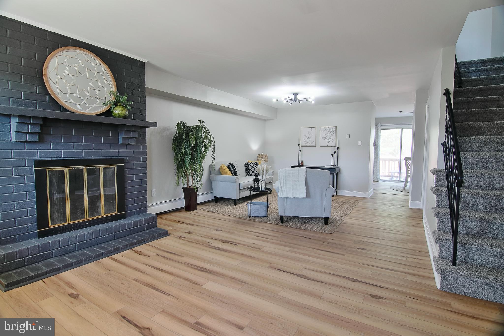 This Walnut Ridge townhome nestled in the prestigious Pottsgrove School District recently underwent a complete renovation from floor to ceiling in 2024. As you enter the main floor, you're greeted by new luxury vinyl plank flooring, setting a tone of modern elegance. The spacious living room is a focal point, boasting a convenient entry closet on one side and a dramatic painted brick fireplace on the other. This versatile space can be utilized as one expansive room or divided to accommodate a dining area, offering flexibility to suit your lifestyle. Prepare to be impressed by the eat-in kitchen, a culinary enthusiast's dream! It showcases new cabinets, designer countertops, and updated appliances, creating a perfect blend of style and functionality. Sliders from the eat-in kitchen open to your private rear deck and fenced yard, ideal for outdoor gatherings and relaxation or to let your dog run around. A newly renovated half bath on this level enhances convenience and comfort. Venture upstairs to discover three inviting bedrooms and a full bath. The primary bedroom features a private vanity area and direct access to the bath, ensuring convenience and privacy. The finished basement adds valuable living space, perfect for a family room or entertainment area. Throughout the home, you will find upgraded light fixtures that look like they came right from the pages of a catalog. Conveniently located within walking distance to Gerald Richard’s Park, residents can enjoy amenities such as swing sets, playgrounds, baseball diamonds, and more, making this townhome an ideal retreat for modern living. Minutes to Philadelphia Premium Outlets for shopping, and easy access to the Rt. 422 corridor makes this an ideal location. Don't miss the opportunity to make this exquisite townhome your new sanctuary!