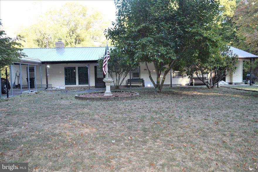 Welcome to your new home on over half an acre of private land that you can make into your own oasis.  You will be less than one mile from the hospital with a very easy commute to both DC & VA. Enjoy the spacious kitchen with plenty of cabinets and space to eat in.  Move next to your inviting family room with beautiful brick and gleaming hardwood floors and enjoy the warmth of the pellet stove. This property comes with a bonus inlaw suite/ apartment with a separate kitchen and entrance.  The one bedroom apartment is the perfect addition to this already wonderful home.  Relax in the back of the house during all seasons with the enclosed patio or move to the front and enjoy the porch.  The front carport is covered and in the bacyard you have a 3 car garage with a cover workstation area.