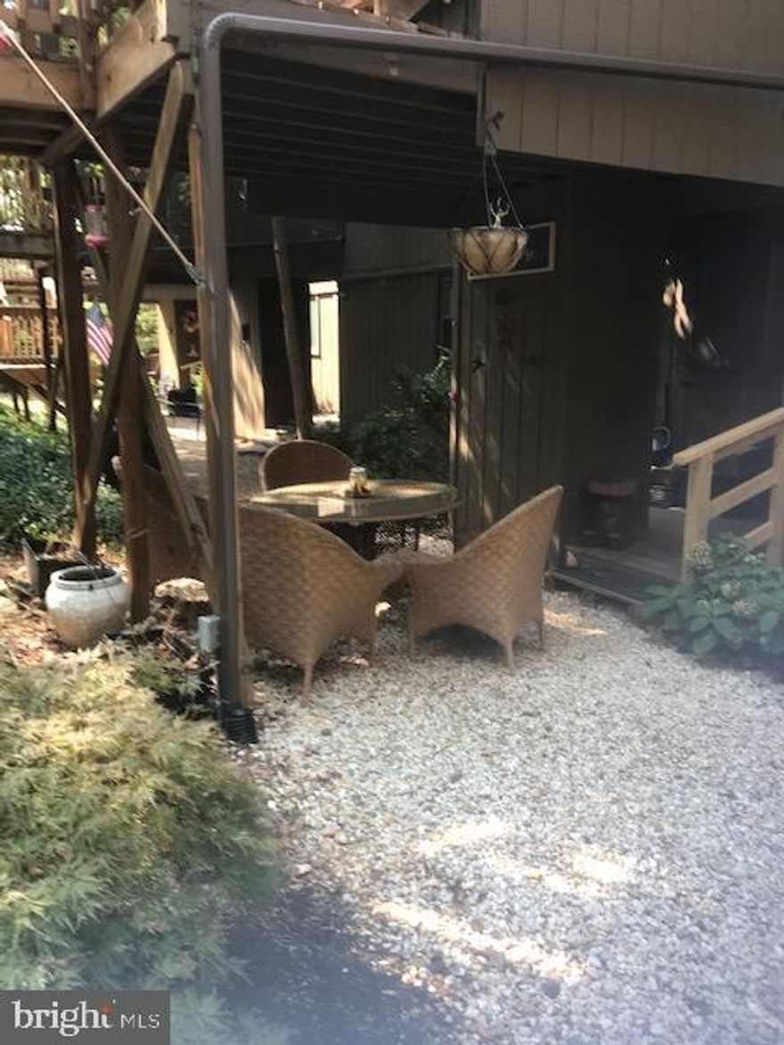 This unique ground floor condo is move in ready and calling your name.  Wood burning fire place, washer and dryer in unit for your convenience.  Newer  windows and floors.  Lovely deck that looks out into nature.  Kitchen with nice backsplash.   New hot water heater in 2021.  Carpet less than 5 years old. Barn door newly installed at one of the bedrooms.  This condo is perfect for full-time living or weekend getaways. Some furnishings to convey.  When entering the unit there is great outside space  with shrubs and enough space for a table.  Great area for entertaining!!