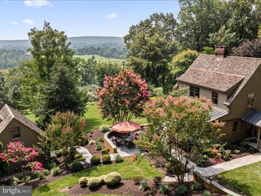 Welcome to an extraordinary home, a custom-built masterpiece located in the prestigious estate area of Buckingham Township PA. Designed by renowned architect Lynn Taylor and constructed by the esteemed builder Jarrett Vaughan, this stylish Arts and Crafts residence offers an unparalleled living experience.
One of the standout features of this property is the inclusion of a guesthouse or in-law accommodations providing additional space and flexibility for the extended family members or guests. The oversized 2 car garage not only offers ample parking but also features a private office and partially finished game room/ flex space above catering to your professional and recreational needs.
Positioned high on the hillside this home boasts breathtaking views of the surrounding lush emerald farmlands creating a serene and picturesque backdrop. The arts and crafts inspired design is evident throughout the residence with an open floor plan and beautiful pine floors adorning the upper and main floors. Additionally, a finished lower-level walkout with double glass doors seamlessly blend the indoor and outdoor spaces allowing for easy access to the expansive yard perfect for entertaining and leisure activities. The lower level also boasts a wood stove for those chilling evenings.
 The exceptional craftsmanship of Jarrett Vaughan is evident in the details.  All further enhancing the overall appeal of the property. Features, include, copper gutters and down spouts, cedar shake roofs, wooden interior doors, custom door handles, Monrovian tiles, entrance garden surrounded by a hand forged antique iron worked fencing and extensive mature landscaping.
Every moment spent in this home is special, as the living room, kitchen, dining room, and main bedroom all offer breathtaking views. Whether you are enjoying a meal with loved ones, relaxing in the living room, or retiring to the main bedroom, the panoramic views will captivate you. Not only is the home aesthetically stunning, but it also boasts modern conveniences. Electronic systems including the alarm lighting and HVAC can be easily controlled through phones or computers providing you with optional comfort and security the ash Mill Road family compound is a rare gem that combines impeccable design quality craftsmanship, and breathtaking views in a coveted location don't miss this opportunity to make this extraordinary property your own and create cherished memories of a lifetime.