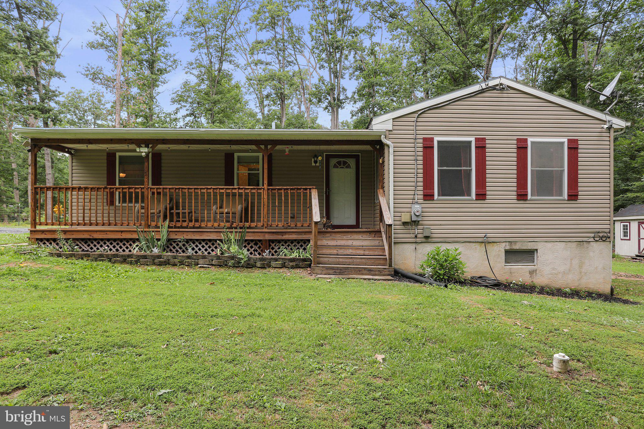 Rancher on over 2 acres featuring 3 bedrooms and 2 baths and partially finished walk-out basement. Cathedral ceiling in living room, nice workable kitchen and good sized bedrooms (and a split bedroom plan). Sit out on the front porch in the mornings to watch the sun rise, sit on the rear deck and watch the sunset. Fenced in lot. Plenty of storage in the large shed and a mix of cleared flat ground and mature trees.