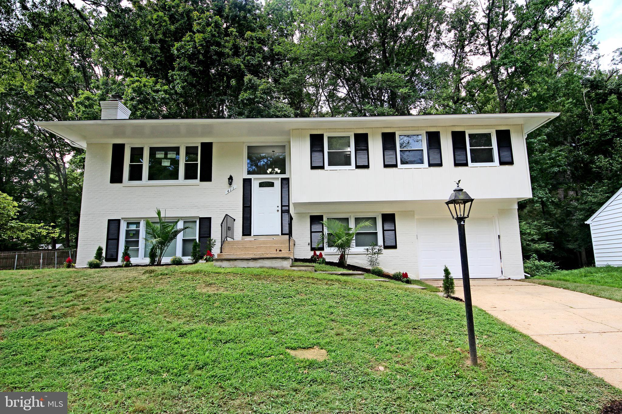 STUNNING 4 BEDROOM, 2 FULL BATHS and HALF BATH home with Huge , Flat Lot, Backs to Trees! MUST SEE: GOURMET KITCHEN WITH Hi-End Cabinets, STAINLESS STEEL APPLIANCES, French 3-Door Refrigerator, EXOTIC GRANITE, GLASS TILED BACKSPLASH, and High-End Light Fixtures in Kitchen. Living Room, Separate Dining Room and Hallway with GLEAMING Floors, Chair-Rail and CUSTOM 2-Tone Paint in Living Room. ALL NEW BATHS with CUSTOM HI-END VANITIES and Mirrors, LIGHTING, EXQUISITE MARBLE and PORCELAIN TILED Walls and Floors. Lower Level has Large Rec Room, Full Bedroom, Full Bathroom, Separate Large Laundry Room, Mechanical Room and Storage . Walk-out to Entertain in your LARGE Flat Fenced Backyard and Patio. Attached Garage and Driveway. ONE YEAR HOME WARRANTY- Paid by the Seller at the Closing!