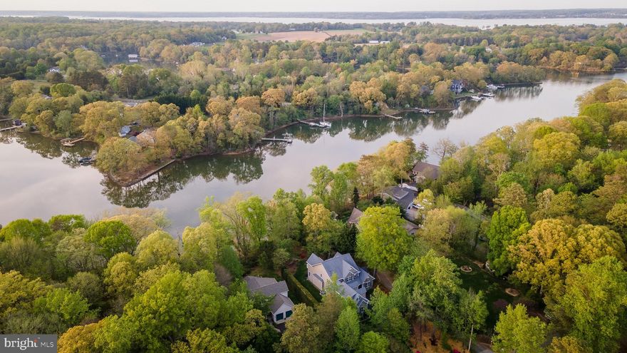 Hollywood waterfront on Cuckold Creek—custom-built, one-owner home offering space, quality, and beautiful water views. The main level features hardwood floors throughout, a primary bedroom with full bath, and a well-appointed kitchen with granite countertops and custom cabinetry, open to the breakfast area and family room with a gas fireplace. A bright sunroom overlooks the creek and provides access to the deck—ideal for relaxing or entertaining. Formal living and dining rooms complete the main level.

Upstairs offers three additional bedrooms with ample space for family or guests. The finished walk-out basement includes a fifth bedroom, full bath, spacious rec room, large storage area, and a dedicated woodshop with built-in benches and shelving.

Enjoy waterfront living with a 50’ pier
