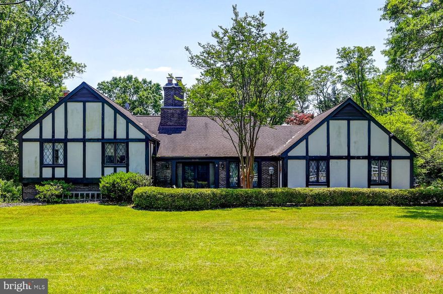 BACK ON THE MARKET PENDING RELEASE!!!   This custom-built English Tudor is a hidden gem in Folly Quarter. This desirable property is located on just under one acre with lush landscaping and tranquil views.   This home also features just under 3,000 square feet of living space, perfect for both casual and formal entertaining.  The large eat-in kitchen boasts upgraded stainless appliances including a double wall oven, electric cooktop, and a bottom freezer refrigerator. The eat-in kitchen also includes a double bowl sink, breakfast room, planning desk, and a beautiful bay window.   The formal dining room is adorned with rich hardwood floors, wood crown molding, wainscoting, and a sliding glass door.  The separate living room includes rich hardwood floors, designer wood wainscoting with crown molding, a stone wood burning fireplace, and a sliding glass door to the maintenance free deck and rear yard.  The upper level provides a large primary suite with en-suite bathroom and dressing room, sliding door access to a private balcony, laminate flooring, and plenty of closet space.  There are three additional bedrooms and a full bath on this level.  The lower level comes complete with an over-sized family room boasting wood floors, a brick front wood burning fireplace with designer mantle, sliding door to the rear deck, and a large wet bar with plenty of cabinetry.  This level also includes a fifth bedroom, full bathroom, and a laundry room with utility sink. Enjoy entertaining on the rear maintenance-free tiered deck or walk just steps to the community pool that can be joined for an additional fee.  Additional features include wood beams, ceiling fans, slate flooring, upgraded lighting, attic with flooring for storage, an oversized side loading two-car garage, and a long driveway for multiple car parking.  This community is conveniently located just minutes from Sykesville, 795, Owings Mills, and 695. Use of RESE TITLE preferred by seller.