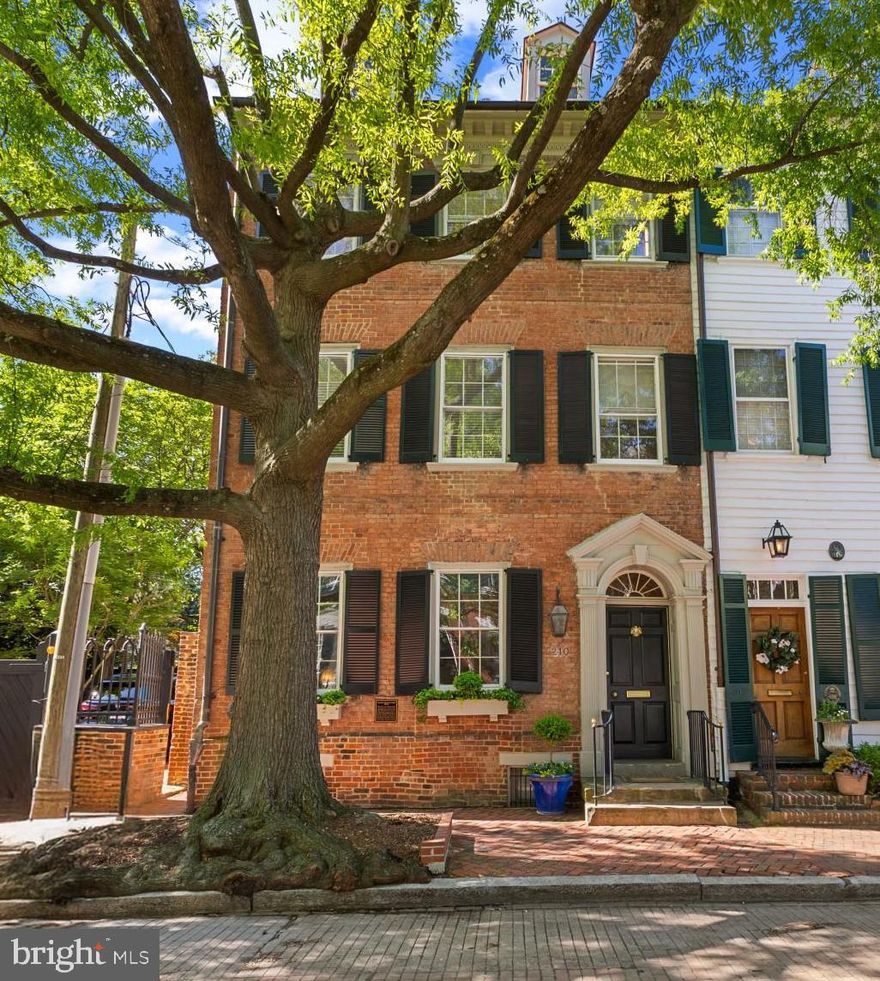 This 1784 residence located on Gentry Row in the heart of Old Town, Alexandria, is a TREASURE!   Exquisite details, custom built-ins, sought-after updates and overwhelming charm characterize every level of this all-brick home.  Classic federal architectural details, a recessed entrance, custom window planters and handsome shutters greet you on one of the sought-after and most famous streets of this historic seaport.
     A lovely entrance hallway, approximately 6 feet wide and 20 feet long, is graced by a keystone window above the front door.  Its 10' ceilings are capped by period dentil molding, chair rail and custom faux paintine wallpaper both above and below the chair rail.  A period fixture is just one of many throughout this home.  Original floors throughout most of the residence, wide pine planks, are both warm and welcoming.
     The stately living room is the first room to the left of the entrance hall and offers 2 deep windows sills with tailor-made covers for active radiators, swag and jabot draperies and custom shutters.  The built-in bookcases, intricate moldings, a fireplace with attractive paneled insets and mantle make evey wall of this room unique and complementary and create a decor that is not just beautiful but reflective of one of the finest examples of early American residential architecture in the historic area.
     The family room, approached from either an arched entry way from the living room, or from  the gracious hallway, is filled with natural light by a large window with southern exposure and defined by elaborate custom drapery.  This end townhouse is filled with north, south and eastern exposures on each level creating the feeling of a detached residnece with well-designed space and interaction with lush natural scenery.  The family room has an impressive trey ceiling, chair rail, moldings within the wainscotting and a custom-designed built-in cabinet which showcases dozens of prized teacups and saucers.  Like the living room, the radiator cover is both stately and practical.
     As one transition to the middle of the home, there is a transom above a 9 pane, 35" wide door opening onto the patio (1 of 3 entrances) to an elegant outdoor retreat space and entertaining area.  There is also a well-designed and lovely 1/2 bath on this level.
     Entertaining in this home often occurs in a beautiful dining room whose complementary wallpaper and draperies are further accented by a 5' double door, two 18" side windows and 4' wide side bay wndows which were designed for capturing natural light and reflecting the beauty of the garden.  Bright and elegant, this dining room also has a large fireplace, period hardware and attractive fixtures which create both elegance and ease of movement both within and beyond this space.  Both built-in china cabinets which flank the doorway passage to the large and renovated kitchen can be pulled out.
     A pocket door allows the owner to close off the kitchen to the dining room if one desired a more elegant and intimate space.  The kitchen boasts of many recent improvements:  a cathedral ceiling, a transom with six window panes and a keystone arch; granite counters with a custom drain board in the countertop, downdraft Thermador 5 burner stove and fan, Pentair water filter, double windows above the sink, beautiful cabinetry, a Cafe refrigerator, a large pot rack which conveys, double wall oven, customized cabinetry lighting, a large microwave and a well designed desk or coffee bar area with customized cabinetry and shelves with glass doors that are both elegant and efficient.
     The outdoor entertaining space  hosts a built-in gas grill, a custom designed sink & stone counter working area.  An irrigation system preserves this award-winning garden designed by the owner who is a long-time honored member of the Garden Club of Alexandria.  (see Complete Description in Documents)