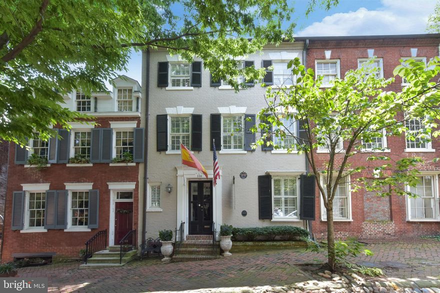 Welcome to 116 Prince St (Circa 1770) This stunning Federal brick townhouse located on famed "Captains Row" in the heart of Old Town has a storied history and has recently undergone a thoughtful renovation. The recent updates maintain the historic character of the home with its original 250 year old heart pine plank flooring and moldings and builds on the European heritage with a Boffi kitchen, Porcelanosa baths and crystal chandelier lighting. There are 5 bedrooms with 3.5 baths and 3 fireplaces in over 4,300 finished SF. The kitchen opens to a welcoming family room with a woodburning fireplace and French doors leading to a charming slate patio with a tiered, walled garden featuring an outdoor living room perfect for entertaining around the gas firepit and private spa. The owners level master suite has a large living room with a fireplace and private deck overlooking the garden. The top floor has been finished to provide a huge game room with windows to Old Town rooftops and the Potomac River. The lower level has been finished with higher ceilings, a spectacular Porcelanosa bath, and a private bar complete with a wine wall and a third fireplace. Just one block from King Street, Captains Row is one of 2 historic cobblestone streets in Old Town Alexandria. Fireplaces convey as is. Shown by appointment only. This is a York Group Listing.