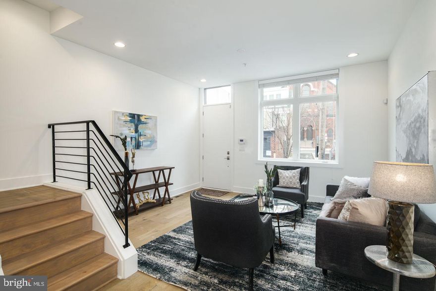 Welcome to 336 Potts Place, a beautifully appointed home offering the perfect blend of style, space, and convenience in sought-after Northern Liberties—complete with parking, a roof deck, and tax abatement. This 3-bedroom, 2.5-bath residence features rich hardwood floors throughout and a bright, open-concept main living area filled with natural light from oversized windows. The seamless flow from the spacious living room to the dining area and additional bar seating leads into a stunning kitchen with sleek tile backsplash, stainless steel appliances, and ample cabinetry—ideal for both everyday living and entertaining. Upstairs, you’ll find three generously sized bedrooms with excellent closet space, including a serene primary suite with a walk-in closet and a spa-like ensuite bath featuring a beautifully tiled shower and double vanity. Just steps away, your private roof deck offers the perfect escape with sweeping city skyline views. Photos are of a similar unit in the development. Taxes and square footage is the responsibility of the buyer to have verified independently.