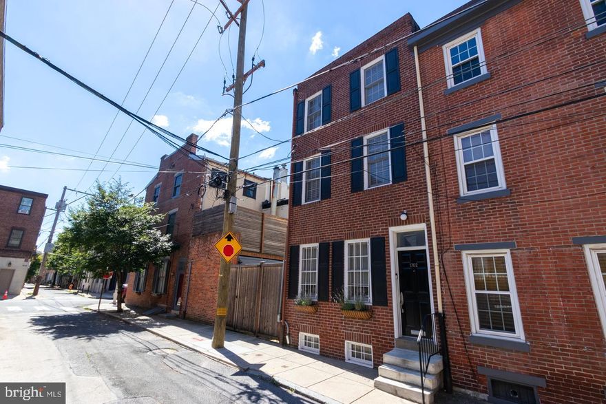 Welcome to this beautiful home on charming Naudain Street. Enter into the newly renovated kitchen equipped with Fisher & Paykel appliances along with elegant details throughout. This semi-open floor plan leads to a spacious living room that opens up to a backyard patio with access to the hidden gem of Old Carver Street Park. The 2nd floor has two bedrooms and one full bathroom. The 3rd floor features a vaulted ceiling, sitting room with a Juliet balcony, fireplace, walk in closet, full bathroom and bedroom. This home is in pristine condition! All of the rooms feature custom window treatments. Walk to Rittenhouse square in minutes. Close to everything the city has to offer!