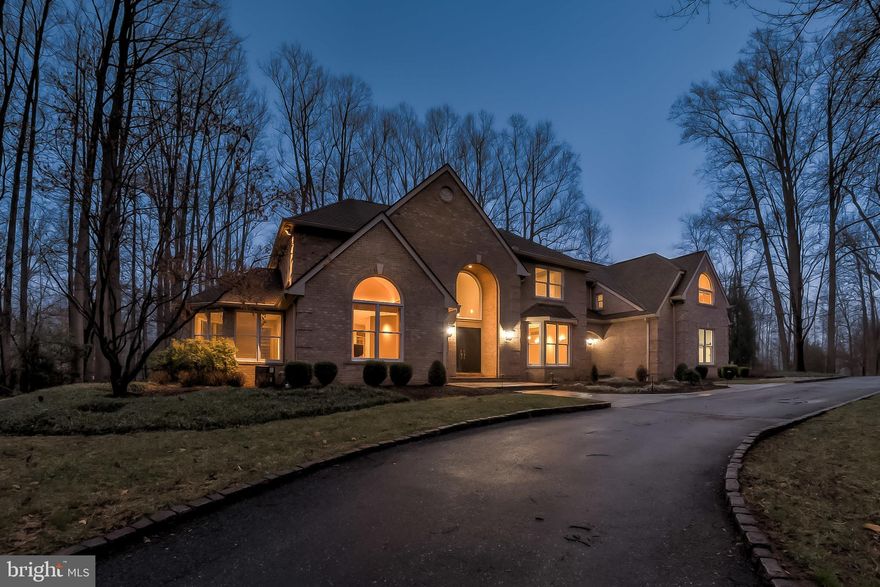 A circular drive approach introduces this all brick 7,984 sqft custom manor home sited on 1.47 landscaped wooded homesite backing to the 13th Fairway of the Hobbits Glen Golf Course. Hand carved double doors welcome you with grace and style into the dramatic 2-story foyer showing marble inlaid flooring with woven hardwood framing, a curved staircase leading to an overlook, Palladian windows, high ceilings, stunning hardwoods, a 3-level elevator, art niches and fine architectural details. Natural light bounds in this home featuring a bay window in the dining room, a living room, a richly appointed library with a deck walkout, and a sunken family room accentuated by lighted stairs, a wall of windows, a 17' cathedral ceiling, an ambient fireplace, and 2 walkouts to expanded outdoor living spaces. Enjoy preparing meals in the gourmet kitchen boasting extended workspaces, lustrous panel cabinetry, sleek granite counters, tile backsplash with decorative inlays, top-of-the-line appliances,  a large pantry, a convenient workstation and desk, a well-designed curved island, and an adjoining breakfast room with buffet providing a relaxed dining experience, and glass slider accessing the Trex deck. Amazing yet relaxing, the owner's suite resides on the upper level and is adorned by a lighted tray ceiling, a shiplap feature wall, a coffee bar, 2 walk-in closets, a private balcony, a sitting room with a screen and projector, and a deluxe bath displaying an oversized frameless shower, new flooring, a double vanity with a center dressing table, and a cathedral ceiling atop a platform soaking tub. Downstairs you will find a world of enjoyment showcasing a movie theater with custom leather doors and a cafe, a full bath, a bedroom, a half bath, and a game area, and a home office with built-ins and a walk-up to a private expanse of trees and landscaped backyard. This elegant home is within easy reach of Hobbits Glen golf course, cultural centers, airports, commuter routes, stylish boutiques, exceptional dining, and more!