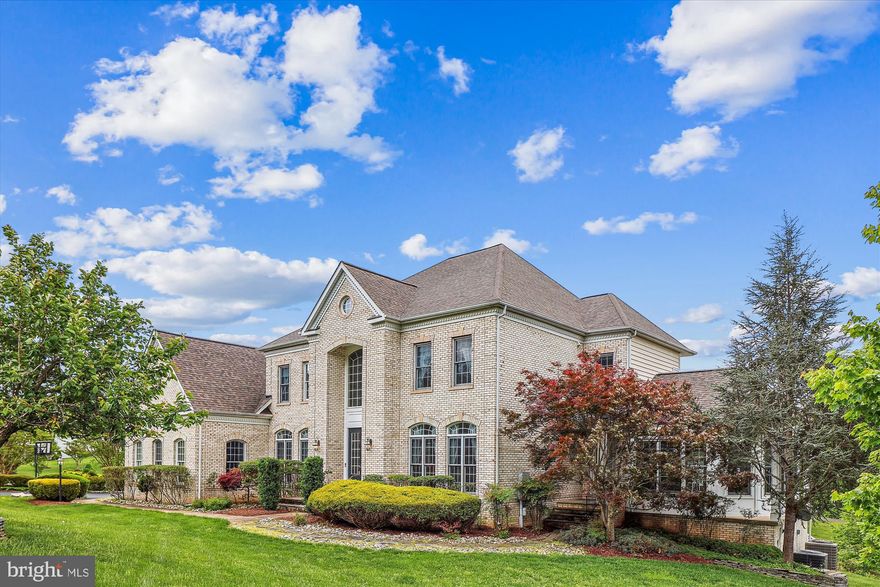 In search of a larger home?  This beautiful versatile home has everything you need from the main level primary suite with bright sunroom, to the grand upper level primary suite + 3 upper level ensuite bedrooms, and two additional bedrooms and two full baths in the walk out lower level.  Be prepared to be impressed by almost 10,000 square feet of living space across 3 levels.  The well planned main level offers hardwood floors, a gorgeous two story entry foyer with stunning curved staircase and flexible living space with a pretty front sitting room, elegant dining room with chair and crown moldings and a convenient Butler's pantry, expansive kitchen with a center island, walls of cabinets and counter space, a sunny breakfast/morning room and a walk in pantry.  The two story family room with soaring walls of windows, coffered ceiling, cozy gas fireplace and back staircase is perfect for relaxing and entertaining with its handy deck access where you can enjoy views of nature all year round.  The mud room leading to the 3 car garage is also a convenience that's sure to please. The finished lower level offers additional comfortable living spaces with your pick of two recreation rooms, a charming wet bar, media room and walk out with back yard access.  Updated and move in ready with fresh decor, recent roof, heat pumps, water heater, grinder pump, and so much more!  Enjoy close proximity to every convenience - shops, restaurants, Downtown Kentlands, commuter routes and anything else you desire!