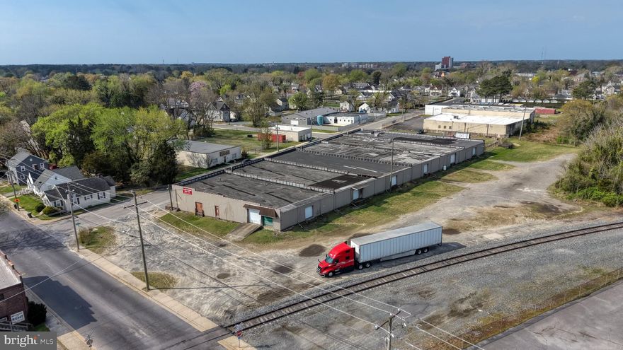 Exceptional Industrial / Flex Warehouse Opportunity – Turnkey 
831 Benny Street | Salisbury

Position your business for efficiency and growth with this outstanding warehouse and office facility, strategically located near U.S. Route 13—the region’s primary commercial corridor. This prime location offers excellent accessibility for logistics, service operations, and regional distribution.

This versatile facility features 12 overhead doors and a dedicated loading dock, providing seamless logistics, multiple access points, and efficient flow for shipping, receiving, and large-scale operations. The layout is ideal for high-volume users requiring flexibility and efficiency.

A major highlight of the property is the large, fenced-in blacktop yard, designed to accommodate multiple tractor-trailers with ease. This secure exterior space supports equipment storage, fleet parking, and operational staging. In addition, the site offers approximately 15 dedicated parking spaces for staff and visitors.

Inside, the building is outfitted with extensive shelving and storage systems, maximizing warehouse functionality. The property also features a substantial office buildout, including multiple private offices, conference rooms, and administrative areas, allowing for seamless integration of operations and management.

The facility is further enhanced by numerous restrooms and employee support areas, making it well-suited for businesses with larger teams or multi-department operations.

Key Highlights:

Prime location with quick access to Route 13
Overhead doors + dedicated loading dock
Multiple points of entry for operational efficiency
Large fenced, blacktop yard for truck parking and storage
Capacity for multiple tractor-trailers
Approx. 15 on-site parking spaces
Extensive shelving and storage infrastructure
Multiple offices and conference rooms
Numerous restrooms for staff
Turnkey condition – ready for immediate occupancy
Ideal for distribution, storage, service operations, or light industrial use