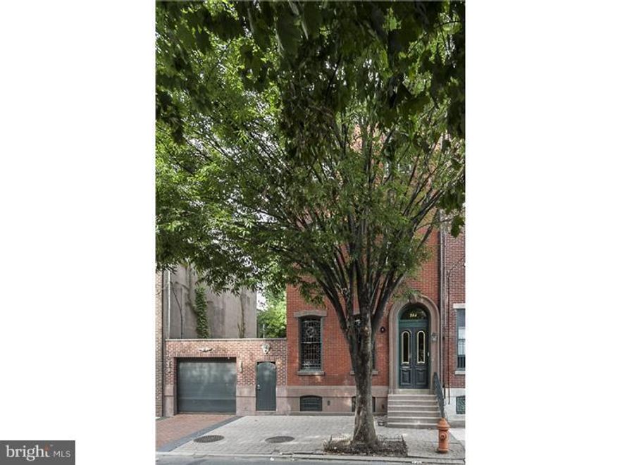 DESIGNED WITH DISTINCTION. Stunning, award-winning double property (circa 1850 - Historically Registered). Completely renovated this 5 bedroom, 3.5 bath home offers classic details with modern amenities and state of the art systems. The formal living room offers 12' ceilings with hand stenciled borders, magnificent stained glass windows, fireplace and original pumpkin pine floors. The dining room features a marble fireplace and double custom French doors opening to a terrace. A Chef's kitchen, winner of "Best Kitchen Renovation" award with custom maple cabinets, granite countertops and Italian tile floors. Atrium room with bay windows is drenched in sunlight featuring  20' ceiling and balcony. The main suite has a large walk in closet, sitting room, fireplace a European Bath + a lovely private balcony with a terrace overlooking the gardens. Professionally designed grounds feature brick and flagstone terrace with a fountain plus two car off-street parking. Main Line Elegance in the City.