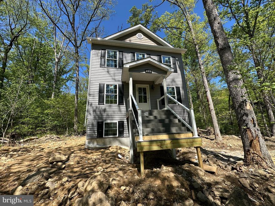 5-6-26   Going to paint and hardwoods  and down.  Delivery end of April.  
Current Shawneeland Inventory
208 Beaver Trail
210 Beaver Trail
212 Falcon Trail
211 Inca Trail
103 Tonto Trail
123 Killbuck Trail
1/3 Acre – No Carpet!
This affordable 2-bed, 2.5-bath home offers high-end finishes and incredible growth potential.
Premium Finishes: Hardwood floors throughout (including all bedrooms), tile in all baths, and granite kitchen countertops.
Open Layout: Bright family room and a spacious kitchen/dining area perfect for entertaining.
Owner’s Suite: Large master bedroom with a dedicated walk-in closet and a "true" master bath with double sinks.
Expansion Ready: The basement is already roughed-in for a future bath and features a radon vent pipe, offering a path to nearly double your living space (up to 1,728 sq. ft.).
Don't miss out on this opportunity—contact us for more details!
Xfinity available.