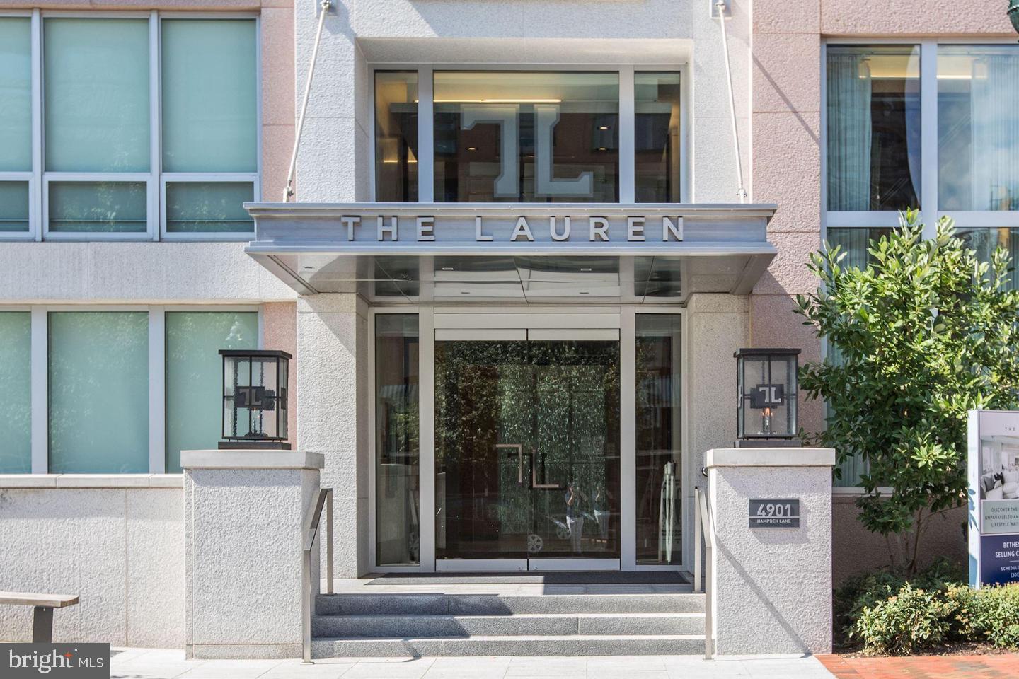 Welcome to "The Lauren," an exquisite 2016 boutique luxury condo building and a jewel in downtown Bethesda! A quiet, light-filled corner residence on the main level, #107 is 2,264 sq. ft. of fabulous living space, from the welcoming foyer entrance with two double coat/storage closets and media closet to the glorious kitchen with high-end commercial grade stainless steel appliances, marble countertops, premium white cabinetry, and oversized island/breakfast bar into the combination dining room and living room with built-in shelves and a gas fireplace. This space also features a nicely sized den/office with pocket doors and a powder room with custom wallpaper. The large and well-designed laundry room leads to the tranquil primary suite with its abundance of closets, including a large walk-in closet, and the primary bath with a dual sink vanity, soaking tub, and separate standing shower. The 2nd bedroom suite includes an ensuite full bath. Hardwood flooring, high and/or tray ceilings, and remote-controlled shades are throughout the condo. The sale includes two garage parking spaces (#60 & #61 - with a personal EV charging hook-up), a storage unit (#19), and a private wine locker. The buildings' amenities include an elegant lobby with 24-hour concierge & secure access, on-site management and engineering staff, rooftop terraces with a catering kitchen & grilling area, the Onyx Lounge/party room with a catering kitchen (a great space to host events/parties), a gym/fitness center, and bicycle storage. And just outside the building are all the shops, restaurants, etc., of downtown Bethesda, with the Bethesda Metro station only a few blocks away.
