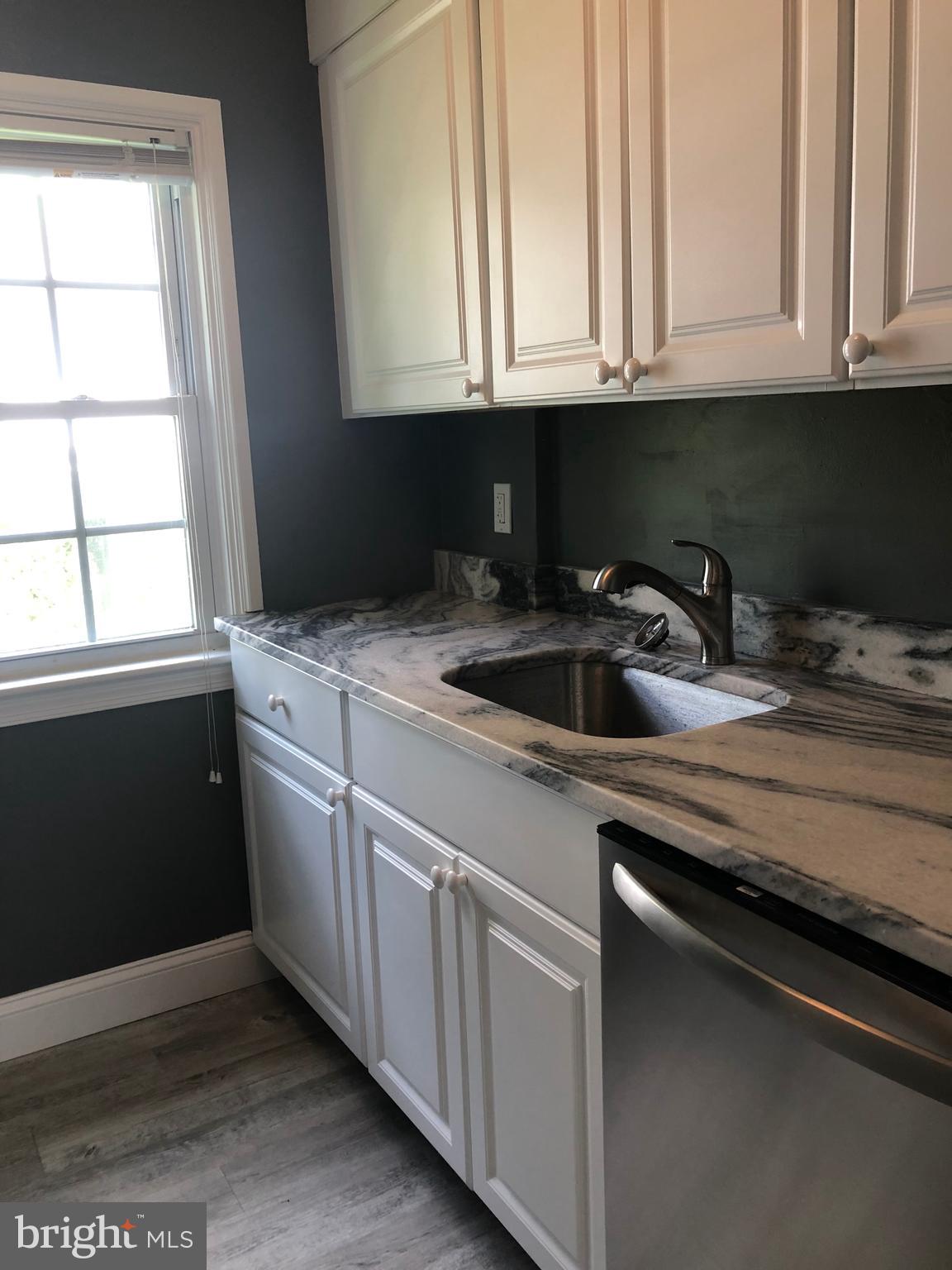 Fabulously renovated walk to Wayne 2nd floor apartment. Located on a quiet nook in Wayne, Radnor Township. It features a new kitchen with leathered granite countertops, stainless steel appliances including a new dishwasher, new microwave, new stove/oven. Spacious dining area and bright living room plus 2 nice size bedrooms and a fully renovated bath. Central air, new carpet, new light fixtures, private laundry in building. Grassy area to enjoy outdoors and coveted location- walk to downtown Wayne with its plethora of restaurants and shops and the train to Philadelphia. NO PETS PLEASE.