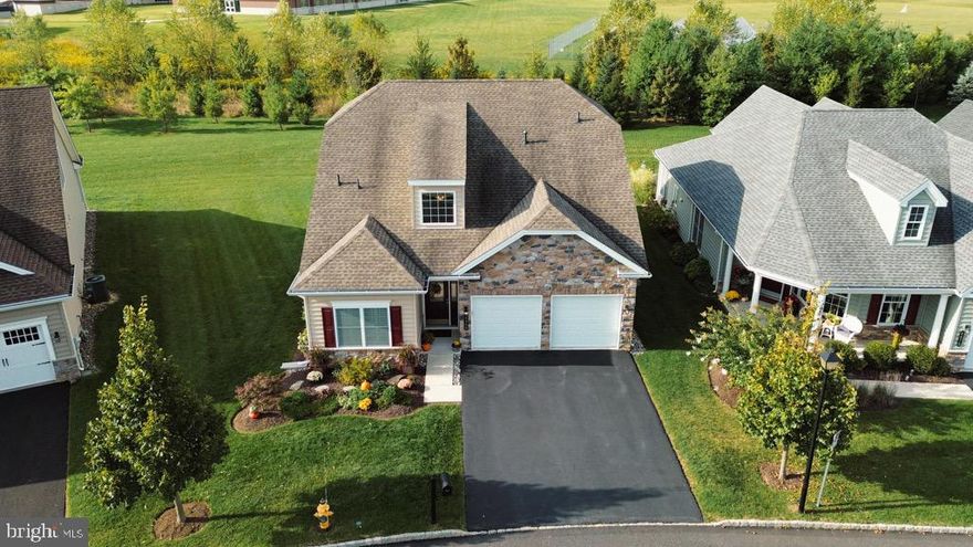 Welcome to your impeccably maintained, move-in ready, custom-built home in the highly desirable Traditions of America at Saucon Valley, a premier 55+ community offering the perfect blend of comfort, convenience, & resort-style living. This beautifully designed home features main-level living with an open-concept layout, including two spacious primary suites on the first floor, each with walk-in closets enhanced by custom built-ins. The elegant kitchen boasts a large center island, granite countertops, a gas stove with vented hood, & opens to a warm and inviting family room with hardwood floors and a gas fireplace framed by built-in shelving. Step outside to your oversized private patio, backed by a serene tree line—perfect for morning coffee or relaxing evenings as you take in the sunset. The second floor offers an additional bedroom and a versatile loft, ideal for guests, a home office, or a hobby space. Enjoy true maintenance-free living with an HOA that takes care of lawn mowing, shrub trimming, snow removal, weed control, mulch, trash, and recycling, so you can spend more time enjoying the community’s exceptional amenities. Live the resort lifestyle every day with access to a clubhouse featuring a sports bar, fitness center, aerobics room, heated outdoor pool, tennis/pickleball courts, walking trails, and a full calendar of social events and activities. All of this just minutes from major highways and the upscale shopping and dining at The Shoppes at the Promenade.