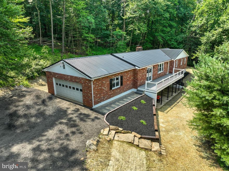 Escape to a secluded oasis in this newly renovated ranch home. Nestled on a wooded lot, this property features 4 bedrooms, 3 baths, and an open floor plan. Modern upgrades include a new roof, deck, floors, windows, doors, paint, and HVAC system. The spacious kitchen has granite countertops and a large island. Relax on the large deck overlooking a pond. Unleash your creativity with the full unfinished walkout basement. This hidden gem also offers potential for short-term rental income. Embrace the extraordinary harmony of nature and contemporary living on this captivating ranch home nestled on 5.4 acres of secluded serenity.