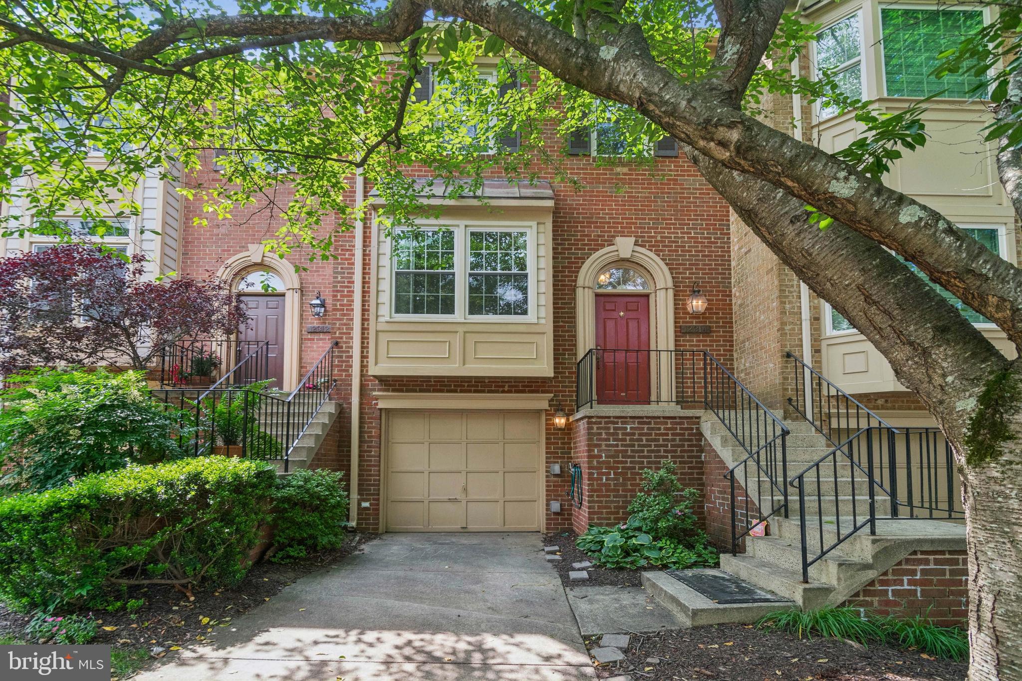 Welcome to this well-maintained garage townhome in the sought-after Potomac Grove community, backing to open green space and a tot lot. Conveniently located near shopping, parks, and major commuter routes, this home offers both comfort and convenience.
Inside, you’ll find a bright and open floor plan filled with natural light from multiple skylights. The main level features fresh interior paint, hardwood floors throughout, a formal living room with a box bay window, a separate dining room, and a convenient half bath. The updated kitchen includes 42" cherry cabinets (some with glass fronts), granite countertops, a new modern backsplash, stainless steel appliances, an island, and two pantries. The adjoining family room has skylights and opens to a private deck overlooking the trees.
Upstairs, the primary suite offers vaulted ceilings, a walk-in closet, and a renovated bathroom. Two additional bedrooms and a full hall bath complete the upper level—all bedrooms have vaulted ceilings and great natural light.
The finished walkout basement includes a spacious rec room with a fireplace and wet bar, luxury vinyl flooring, a half bath, laundry area, and garage access.
Recent updates include: new roof, larger gutters, and 3 Velux skylights (2020), Trane HVAC (2018), new windows (2024), refinished deck (2024).
This move-in ready home combines thoughtful updates with a prime location—don’t miss it!