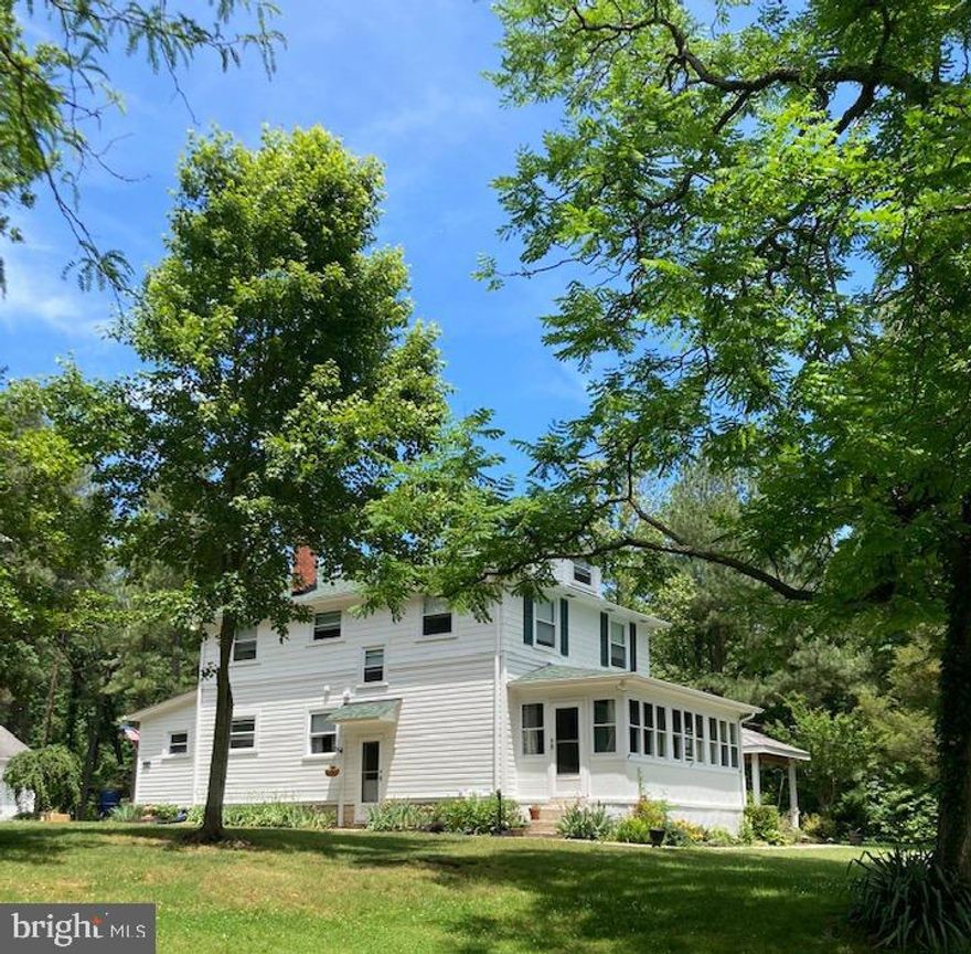 This 1927 Historical home has all the charm of a Period home yet the infrastructure of today.  You enter the front into the fully enclosed front porch.  The quaint foyer welcomes  your guests with a view of the steps, the hallway (half bath location) and into the family room. There is hardwood throughout most of the house. The kitchen, situated in the left rear of the home, has all the modern appliances & features a walk in pantry where the fridge is located.     The family room (front right) has built in shelves on each side of the fireplace. The dining room (or extended family room) features large windows along the side allowing natural sunlight to flow in while offering a lovely view of the side porch and garden.        Upstairs are 3 bedrooms and one full bath.  The 4th room is what ever you need it to be. Currently used as an office.  The owners had plans to create a main en suite in that area, creating a 2nd full bath upstairs. Just a thought to consider.          The attic has pull down stairs , features an attic fan with thermostat. The rafters and flooring leave possibilities to create an open loft area.
New roof and sheathing installed Nov 21, 2016. HVAC unit (inside and out plus new 2nd floor return) installed 2015. Windows were updated in 2000 all are working properly. Natural gas is used for the heat, hot water, stove and fireplace.  There is an additional line available in the garage for heat. Internet is serviced by fios. There are NEW 10 yr smoke and cm detectors throughout the house.           In 2019 the concrete basement was waterproofed with a state of the art French Drain system including new sump pump with battery back up.
There is a termite SENT system in place with a contract through 2/2025. In 2019, a new electrical system was installed including a 200 amp meter.  In 2022 a new roof top chimney was installed (fireplace) as well as a new flue in the gas heat chimney. This home has public water and a septic system. In 2020 a new pump and baffle were installed, it also includes an interior alarm system. The owners have paperwork for the maintenance over the years.  In 2019 the  exterior was painted and new shutters installed.       The garage is huge with room for 2 cars, a work area and a full storage room in the back. Plenty of room for a tractor and other yard equipment and furniture.  The driveway & parking area along with the 5 acre yard, allows for plenty of parking for that special event.
402 Philadelphia Rd has been in the same family since it was completed in 1927.  The home was originally constructed using 2 homes from The Village at Perry Point. The homes were deconstructed and transported to the new location and used to build the current house. 
There is a driveway agreement in place with the home at the bottom of the driveway.