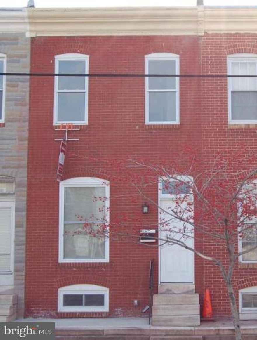This house is located just a few blocks from Ravens stadium and TONS of new development! Same owners for the past 12 tears this house was completely rehabbed in2009.  Features a modern open floor plan with hardwood floors and exposed brick throughout. The first floor opens to a living and dining area combo with a large eat in kitchen. Half bath on the first floor leads out to a rear courtyard and PARKING PAD!! Large undeveloped green space in the rear of the house. Second floor features  two nice size bedrooms AND a smaller middle/BONUS room that can be a den or small bedroom. A full bath completes this level. The basement has a large family room area for extra living space (currently concrete floor) and a rear storage and laundry area. Plenty of room to store what you need. House was gutted and all systems updated in 2009. Never worry about a Ravens game day as you have your own off street parking!! A little freshen up and move right in to call this place home! House is being sold "As Is" and needs some new carpet and a paint job, otherwise in good shape. Price reflects "As Is" condition. Recent sales on this block have been $170,000-$195,000!  Makes this house a GREAT deal!