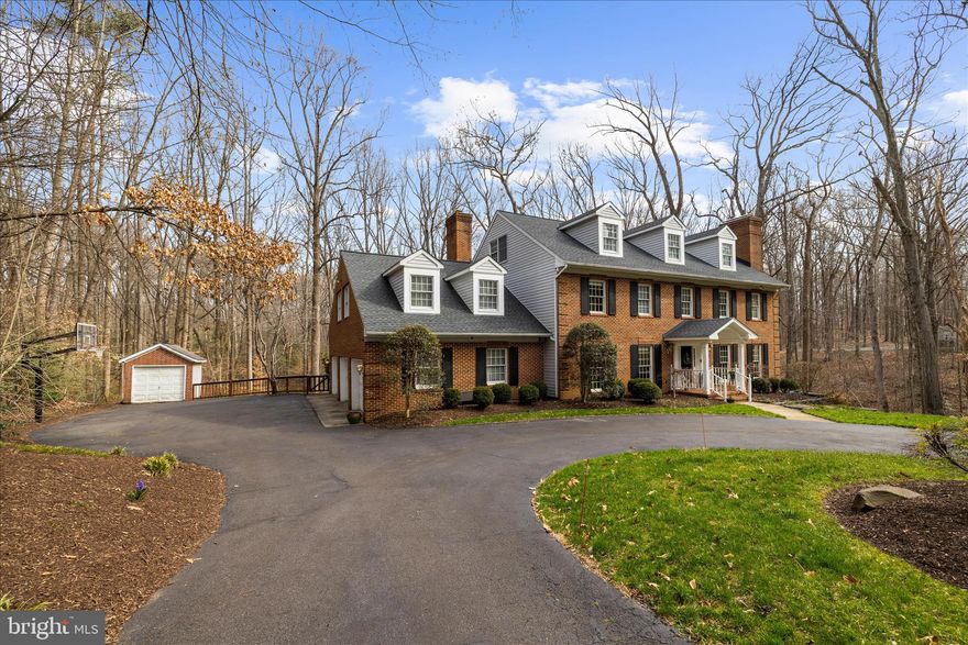 Tranquility and nature awaits you, this timeless all-brick estate offers the rare feeling of living in your own private retreat — while still being just minutes from the heart of Annapolis.
A long private drive opens to a circular driveway welcoming you home, a picturesque landscape with mature trees and open space. A three-car garage and separate shed, there’s plenty of room for vehicles, hobbies, and tools for weekend projects.
Your home unfolds with over 5,500 square feet of beautifully designed living space, where hardwood floors, freshly painted interiors, natural light and generous room sizes create a warm and inviting atmosphere. The main level has 2 living spaces, both with cozy fireplaces, a formal dining room and an office, that could be a main level bedroom.
The 2nd level features four spacious bedrooms and two full baths, along with a large bonus room over the garage that offers endless possibilities for a playroom, studio, or secondary living space. Your large primary bedroom is complete with your private fireplace and large private bathroom with a soaking tub, separate shower and dual vanity.
The 3rd upper level provides two additional bedrooms and a full bath, creating a private retreat perfect for guests, an au pair, or multi-generational living.
The finished lower level adds even more flexibility with a large recreation room, exercise space, and abundant storage. Complete with a walkout to a second patio leading to your generous backyard.
The lower level backyard has a secluded area perfect for bonfires and smores among friends and family.
Your outside experience awaits you with an expansive deck overlooking  the surrounding woodland, 2.25  acres— an ideal setting for summer dinners, quiet mornings with coffee, or spending time listening to nature- perfect for decompressing. Fresh eggs, from your very own chicken coup! Chickens will convey if buyers wish.
Perfectly positioned for your private oasis, located is just minutes from Annapolis, the Naval Academy, commuter routes and local shopping.
A rare opportunity to enjoy space, privacy, and nature while staying connected to everything the Annapolis area has to offer.
