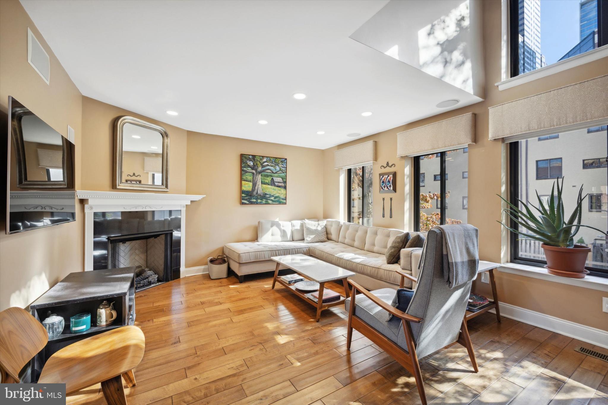 Welcome home to this stunning 4-floor townhouse with garage! This modern home is located on a quiet street in the historic Logan Square neighborhood - minutes away from the Schuylkill River Trail, 30th St Station, Ben Franklin Pkwy Museums, and so much more! Also in close proximity are multiple grocery stores, Coxe Park for family enjoyment, bus and train lines, and major roadways for ease of commuting. From the home's entry foyer, you'll find access to the 1-car garage, a rarity in Center City! This level also includes 1 bedroom with ensuite bath and access to the private fenced patio with new pavers. Head upstairs to find a spectacular living space with dramatic 2-story windows flooding the space with natural light! Cozy up by the gas fireplace in the living room, or entertain in the kitchen/dining area, which features stainless appliances, granite countertops, island with breakfast counter, and room for a dining table. The next floor up includes 2 bedrooms with ceiling fans and double closets, and a hall bath with tub shower. The top level showcases the spacious carpeted owner's suite with patio access for breathtaking views of the city! A walk-in closet with laundry and an additional closet offer ample storage space, and the ensuite bath features a dual sink vanity and separate soaking tub and glass shower. There is an additional laundry hookup on the entry level, hardwood flooring on 3 levels, brand new roof, A/C unit, and balcony railing! Located in the Albert M. Greenfield School Catchment. This beautiful home is not to be missed! Schedule your showing today and make it your new home!