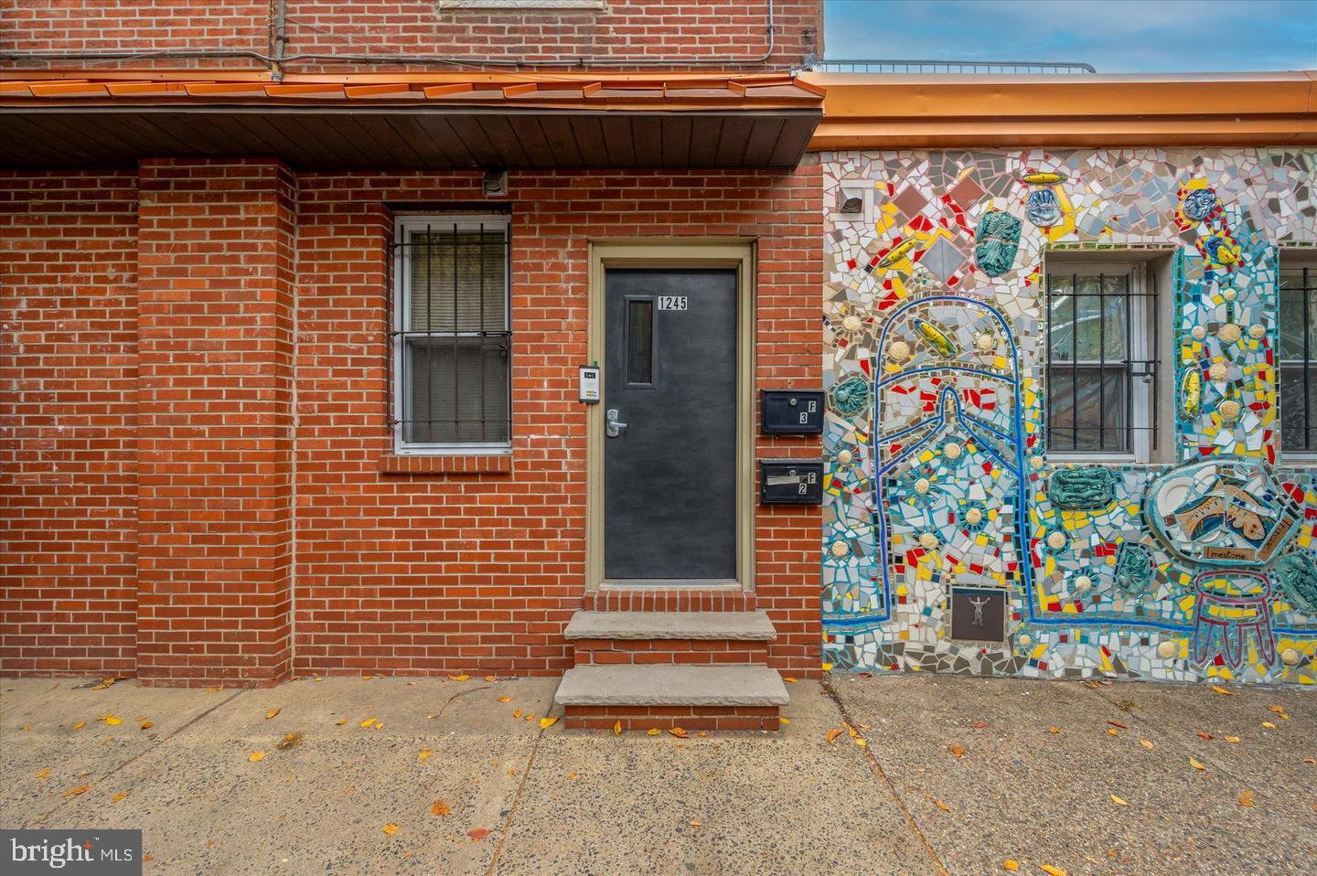 ** MORE PHOTOS COMING SOON** Welcome to your new home in the vibrant and eclectic Passyunk Square! This delightful two-bedroom, one-bath residence perfectly blends modern comforts with the character of the neighborhood, starting with its front entrance, framed by an iconic Isiah Zagar mosaic that’s as much a work of art as it is a welcome home.
Step inside to find a bright and airy living space adorned with stylish finishes and an abundance of natural light. Both bedrooms offer a peaceful escape, with plenty of room to make them your own.
Located just steps from the renowned Italian Market and Passyunk Square, you’ll enjoy an array of artisanal shops, delicious eateries, and local markets right at your doorstep.