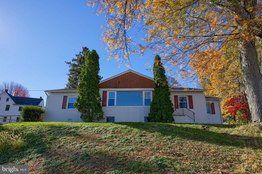 Welcome to this inviting ranch-style home offering convenient one-floor living. The home is a blank canvas awaiting your personal touches to make it your own. The paved driveway comes to the back of the home leading to the attached one car garage. The garage opens into the sunroom and leads you to the kitchen door. The kitchen has plenty of cabinet and counter space. The open living and dining area, complete with a cozy fireplace and hardwood floors, provides the perfect space for relaxing or entertaining while taking in the spectacular views of the city skyline and distant mountains all from the bay window. Two well sized bedrooms offer great natural lighting, hardwood floors and good closet space. At the end of the hall a third bedroom was converted to a bonus room great to use as an office, or study. This space could easily be returned to a bedroom by replacing the door. A walk-up attic offers excellent storage. The finished lower level is spacious and can be used as a game room, and hang out spot with the included pool table. It also includes a laundry area and a full bath. The sunroom is large with a flagstone floor, giving space to enjoy peaceful mornings or quiet evenings. Skylights and sliding glass doors flood the space with natural light. The sunroom also gives inside access to the fenced area, which is covered with wood chips making it a great place for pets and kiddos to safely exercise, play and connect with the outdoors.