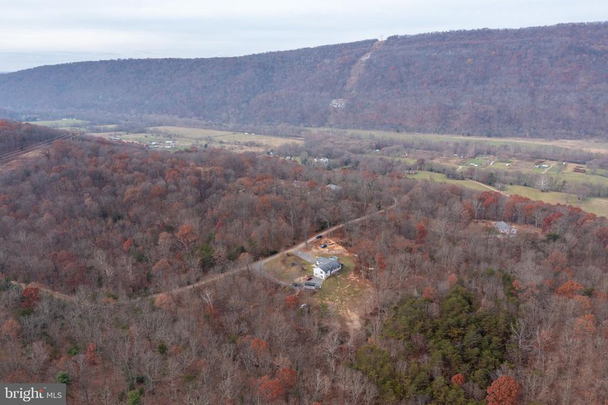 Hello West Virginia seclusion! This 4 bedroom 3 and a half bath rancher has a two-car attached and heated garage and is located just minutes from the South Branch River in Springfield, WV! This quaint home is situated on a little over 8 aces, not to mention, it's UNRESTRICTED! Hunt, ride 4x4s or even build another home on the additional lot. This home comes equipped with appliances and a pellet stove in the basement to stay warm and toasty this winter! The walk-out basement is fully finished and offers a very large bathroom, bedroom and additional family room with outside and inside access.  All of the kitchen cabinets, kitchen island and vanities in the home were hand crafted!  Just imagine enjoying dinner right off of your kitchen on the beautiful patio that offers private, wooded, mountain views!? This property is conveniently located approximately 42 miles from Winchester, VA and 13 miles to Romney, WV.  Call me today and let's make this dream a reality!