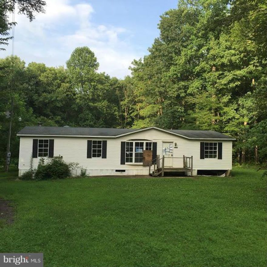 Manufactured home in need of cosmetic repairs. Large lot. Auction style listing. Sold strictly as is, where is.