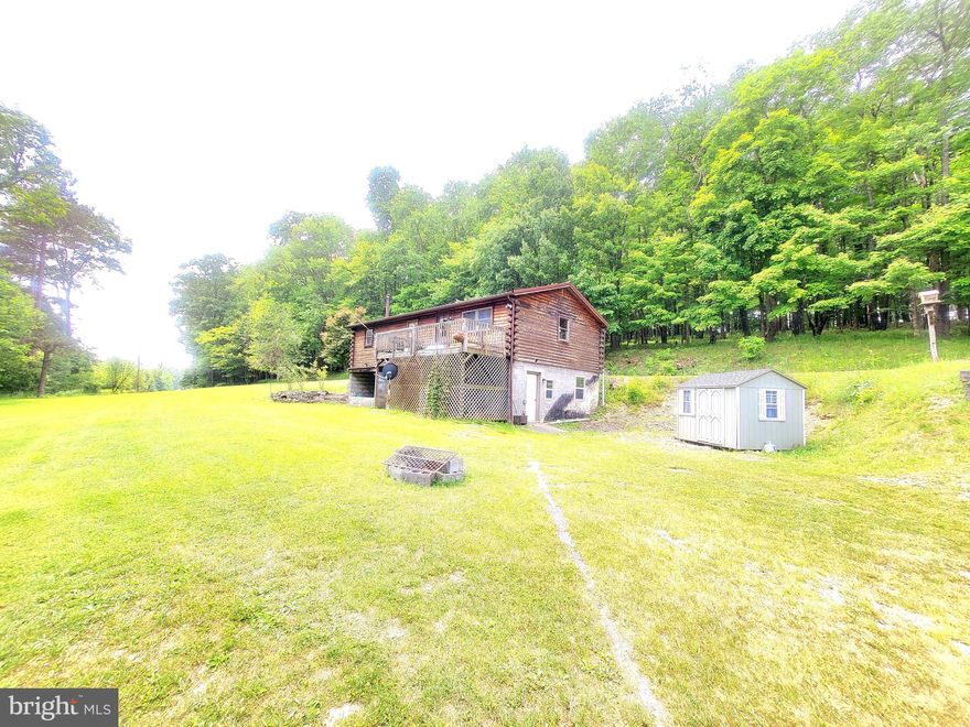 This home sits on 2 lots totaling 15 acres. The views are insane!! It also has a new island in the kitchen and a new primary bedroom and bathroom. The 2nd lot already has public water to the site. So you can sell the additional lot, build an additional home on it, or just keep it for privacy and four wheeler riding.  This home is priced to sell!!