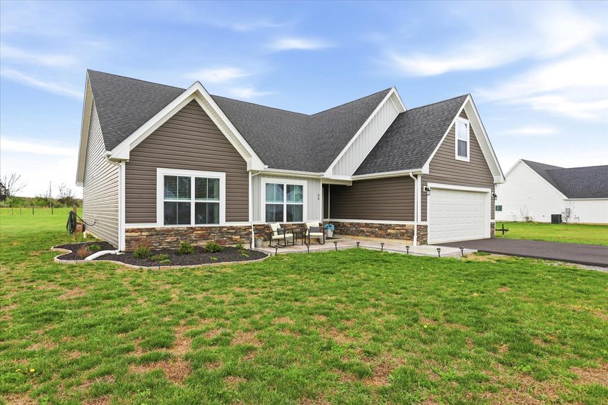 Discover the charm of this beautifully crafted farmhouse-style home, nestled on a generous unrestricted 2.18-acre lot, offering a perfect blend of modern comfort and rustic appeal. Built in 2021, this detached residence boasts over 2,000 square feet of thoughtfully designed living space, featuring four spacious bedrooms and three full bathrooms, ensuring ample room for relaxation and privacy. Step inside to find an inviting open floor plan that seamlessly connects the living, dining, and kitchen areas, ideal for both entertaining and everyday living. The warm tones of the vinyl siding and the farmhouse aesthetic create a cozy atmosphere that feels like home from the moment you enter. Each bedroom offers a tranquil retreat, with the primary suite providing a private oasis complete with an en-suite bathroom. Enjoy the convenience of an attached two-car garage and a spacious driveway, providing plenty of parking for guests. Bring your animals because the expansive outdoor space is a blank canvas for your gardening dreams, outdoor activities, or simply enjoying the serene surroundings. This property is not just a house; it’s a place where memories are made. Experience the perfect balance of comfort, style, and space in this delightful home, waiting for you to create your own story. Don’t miss the opportunity to make it yours! Call or text Joanne today for your private tour.