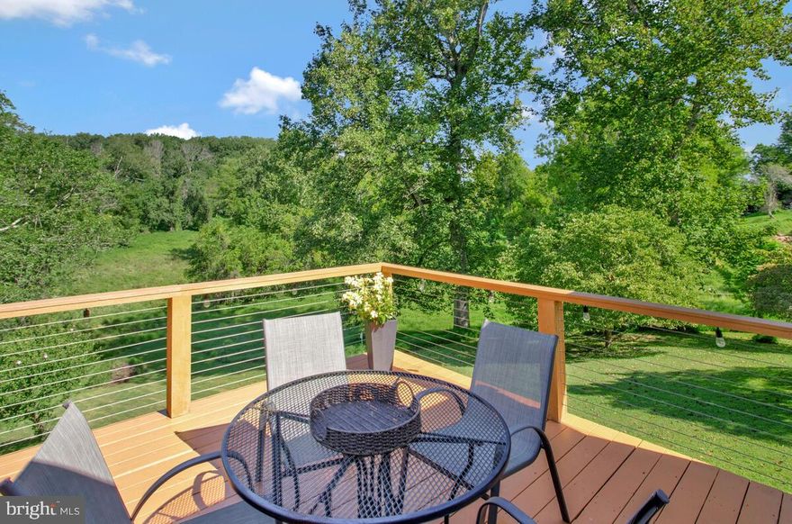 Beauty abounds at 3834 Wards Chapel, where nature, privacy, and scenic views surround you. This charming home combines comfort with easy living. The open-concept kitchen and dining area flow seamlessly, flanked by bedrooms and a fully remodeled bath on one side, and a spacious living room, den, and stylish deck on the other.  The deck, finished with sleek tension rails, allows unobstructed views of the lush greenery and makes a perfect space for outdoor entertaining. On the lower level, you’ll find a laundry area tucked conveniently out of the way, with potential for additional finished living space, with an enclosed powder room  ready for completion.   The oversized garage bay offers ample storage, and from the back of the home, you’ll discover an additional unfinished room—ideal for storage, a hobby area, or future expansion into living or entertaining space.   With so much potential, this home invites you to customize and truly make it your own.   Don’t miss the chance to call this peaceful retreat  your home!