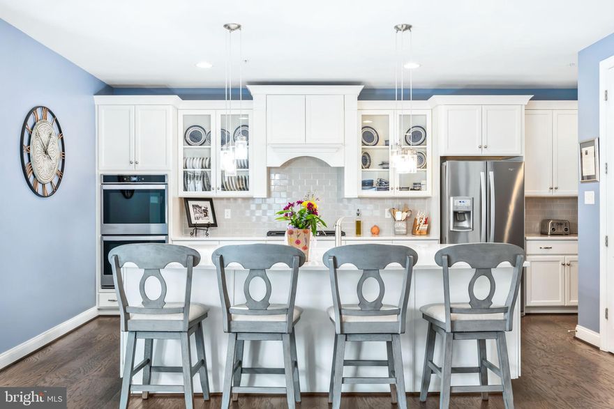 **Welcome to this stunning 5-Bedroom, 5.5-Bath Canton Model featuring nearly 5,000 square feet of beautifully finished living space in the highly sought-after community of Greenleigh at Crossroads in Middle River. Built in 2021 by Williamsburg Homes, this thoughtfully upgraded home blends luxury, functionality, and modern design in one exceptional package.

From the moment you arrive, the expansive composite front porch sets the tone. Step inside to a light-filled foyer where French doors open to a versatile main-level bedroom with private ensuite bath — ideal for guests, a home office, or even a convenient main-level primary suite. Opposite, the formal dining room with crown molding provides the perfect setting for hosting memorable gatherings.

At the heart of the home, the fully upgraded gourmet kitchen impresses with a massive center island featuring a built-in microwave and farmhouse sink, stainless steel appliances with double wall ovens, gas cooktop, quartz countertops, subway tile backsplash, Butler’s pantry, prep area, recessed lighting, pendant fixtures, and stunning 42” white cabinetry. The adjoining eat-in area flows seamlessly into the spacious family room, complete with recessed lighting and a cozy gas fireplace. Durable, waterproof engineered vinyl plank flooring runs throughout the entire main level. A convenient mudroom with garage and deck access plus a stylish half bath complete this level.

Upstairs, you’ll find four generously sized bedrooms, including a luxurious primary suite showcasing tray ceilings, new hardwood floors, a large walk-in closet, and a spa-inspired bath with granite dual vanities, ceramic tile flooring, and an oversized frameless glass shower with built-in seating. One secondary bedroom features its own private full bath, while the remaining two share a spacious hall bath. A utility room with laundry tub and front-loading Whirlpool washer and dryer adds everyday convenience.

The fully finished lower level is designed for entertaining, offering a beautifully appointed wet bar with ample cabinetry and pull-out shelving, recessed lighting, a full bath, and abundant storage space. Whether hosting game day or movie night, this level delivers flexibility and function.

Outdoor living is just as impressive. Relax or entertain on the rear composite deck overlooking the fully fenced backyard with hardscaped patio and firepit. Additional exterior features include vinyl fencing, front porch gate, and negotiable hot tub.

Beyond the extensive builder upgrades, the seller has added thoughtful enhancements including custom shades, upgraded lighting fixtures, ceiling fans, fresh paint throughout, finished basement bath, hardwood flooring in the primary suite, storm door, hardscaping, and more. Dual-zone heating and cooling ensure year-round comfort.

Located directly across from open common ground, this home also offers a 2-car garage plus street parking. Residents of Greenleigh enjoy resort-style amenities including an outdoor pool, clubhouse, fitness center, dog parks, playground, and walkable access to local coffee shops and eateries. You’re just minutes from The Avenue at White Marsh, Gunpowder Falls State Park, and convenient MARC Train access for commuters.

This exceptional home truly checks every box. Schedule your private showing today and explore the 3D tour — this is one you do not want to miss.