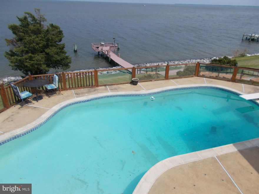 Love Point waterfront with breathtaking  panoramic views of the Chesapeake Bay.  This home has been  lovingly maintained and has loads of character and charm.   Waterfront with a gorgeous pool -- a rarity! 
Astonishing views day and night;  master suite has sliders to pool deck and views of the Bay beyond;  elegant dining room for entertaining; Brazilian Cherry look pergo flooring .  Gas stove , and gas fireplace;  upper level sunny Solarium with floor to ceiling windows and multiple skylights;  gorgeous heated pool with new heat pump, new sand filter and enormous patio decking for entertaining in style; expansive T dock with electric and built-in seating ; fish-cleaning station.  Brand new BAT septic tank and 3, 50-foot trenches installed in2019.  Don't miss a rare opportunity to experience being on vacation every day of your lives in this uniquely amazing home.