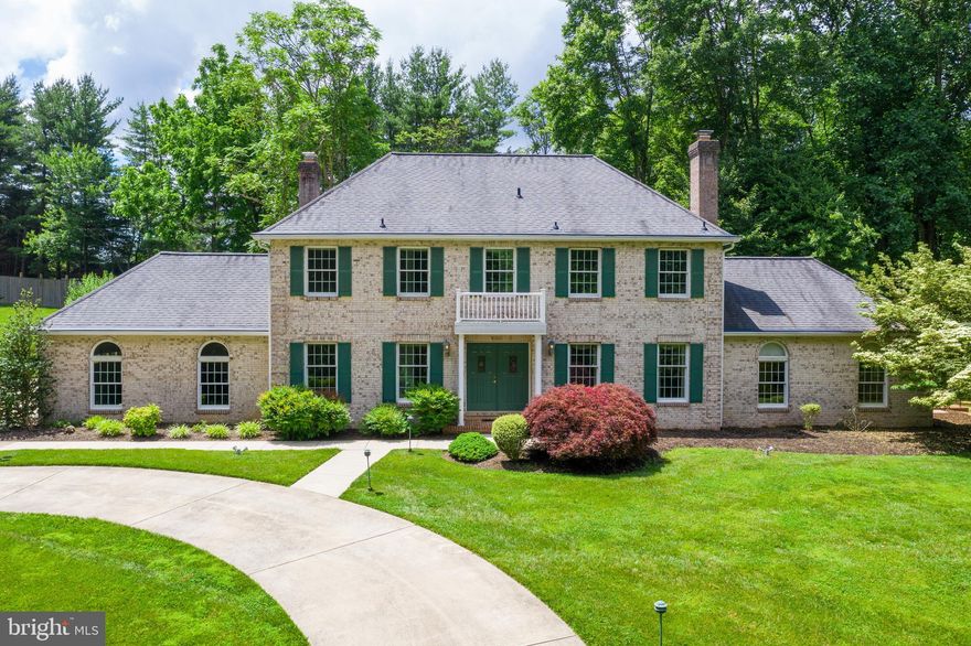 This fabulous 5 bedroom, brick-front Colonial is perched on an incredibly private and park-like 3.49 acre lot in West Friendship. An impressive circular driveway welcomes you to the home. Upon entering the front door, you will notice the bright and spacious main level features gleaming hardwood floors and custom millwork. There is an impressive 2-story foyer as well as a sweeping, curved oak staircase. Large windows grace the formal living room offering captivating views of the professionally landscaped yard. An inviting formal dining room with crown molding, and chair rails provides an elegant space for special get-togethers or intimate dinners. Also on the main level is a private office, offering the perfect space to work from home. The recently remodeled eat-in kitchen is a chef's delight featuring stainless steel appliances, sleek granite countertops, dual wall ovens, and a sunny bay window. Adjacent to the kitchen is the family room with a brick, wood burning fireplace and sliding glass doors accessing the patio and backyard, ideal for hosting indoor/outdoor festive get-togethers. There is a main level bedroom and a full bath--could be used for an in-law, au pair, or even extra office space. A large mudroom/laundry room, and a recently remodeled half bath complete the main level. This home's floor plan makes for easy entertaining as well as comfortable daily living. The upper level features a spacious master bedroom with a walk-in closet and remodeled en-suite bathroom with dual vanity, upscale cabinetry, modern lighting, and over-sized glass enclosed walk-in shower. Three additional generous sized bedrooms, as well as another full bathroom finish out this level. The unfinished basement offers loads of storage space, a utility room, bathroom rough-in, as well as a walkout giving access to the yard and patio. Transform this additional living space however you choose! In addition to the attached 2-car garage, there is a bonus detached 5-car garage-- ideal for a contractor, the hobbyist, car enthusiast, collector, or even an art/yoga studio, or home gym. So many options! The home and detached garage are upgraded with geothermal heating/cooling, offering huge savings on your monthly electric bills. The HVAC is equipped with a dehumidifier/humidifier, Aprilaire filtration, and Honeywell UV air treatment system.   This stately home is on a cul-de-sac in an established neighborhood with large lots and mature trees providing a serene and tranquil setting. Conveniently located close to major commuter routes, shopping, dining, parks, and entertainment. No HOA or similar restrictions.