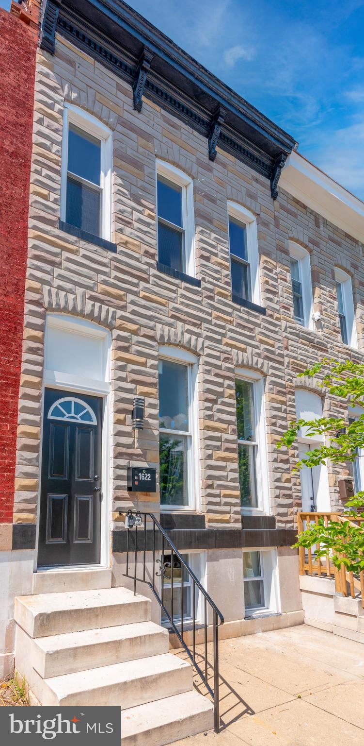 Move-in Ready Townhome Featuring Modern Upgrades in the "Oliver" Neighborhood Of Baltimore City. Discover your dream home! This beautifully renovated townhome in Baltimore City's Oliver neighborhood is fully updated and move-in ready. Interior Highlights • Main Level: Features LVP wood-style flooring, an open-concept living and dining room, a gourmet kitchen with new appliances and granite countertops, plus a convenient half bath. • Upper Level: Also with LVP wood-style flooring, offering three spacious bedrooms and a full modern bathroom. • Lower Level: Includes a partially finished basement for extra space/storage, a laundry area, and updated systems (new forced hot air system with A/C fan, new gas water heater, new gas meter). Key Features & Upgrades Enjoy a parking pad for off-street convenience, a private patio for outdoor relaxation, and modern recessed lighting throughout. This home is smart home ready with living room Bluetooth speakers and boasts a completely new electrical system for peace of mind. Thoughtfully renovated from top to bottom, this home is waiting for you!