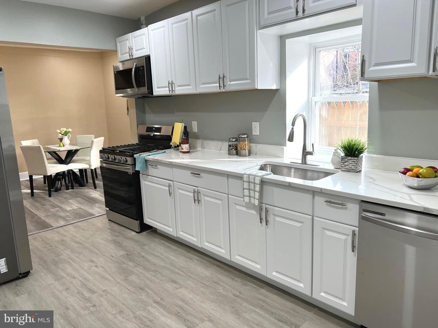 Beautiful renovation,  everything brand new in the house including electric, plumbing, brand new HVAC, water heater, kitchen, bathrooms, windows, doors, trim, fresh paint and flooring. Step into your brand-new kitchen with shaker-style white cabinets, quartz countertops, and stainless steel appliances with gas range. Throughout the main level you will find quality vinyl plank flooring, a spacious dining room, a half bathroom, and a laundry room with front loading washer and dryer. Upstairs you will find a large master bedroom plus two additional rooms and a fully remodeled bathroom. Downstairs is a clean and spacious basement, with plenty of room for storage. Walk into your maintenance free backyard with brand new six foot privacy fence. This is one of the larger models, all at an affordable price and convenient location, just four blocks from Patterson Park. Great for investors too!