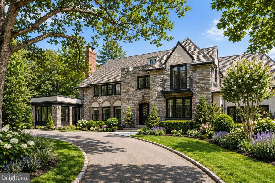 The first two exterior photos are photoshopped.
Set on one of Bryn Mawr’s most picturesque streets, quintessential Main Line residence blends timeless  architecture with exceptional care and beautifully curated grounds. Wrapped in exquisite stonework and crowned with a classic slate roof, this remarkable residence — envisioned by renowned Philadelphia architects Frank Seeburger and Charles F. Rabenold — exudes warmth, character, and enduring elegance from the moment you arrive.
Inside, gracious living spaces are filled with natural light, rich architectural detail, and a seamless flow ideal for both everyday living and entertaining. Oversized windows frame beautiful views of the blooming grounds, while inviting interior spaces offer warmth, comfort, and timeless appeal.
Walk through the signature covered front door entry into a breathtaking reception hall, where a grand soaring staircase sets the tone for the timeless elegance found throughout the home. A formal living and dining space create a warm and welcoming flow ideal for both everyday living and entertaining, while a beautiful Mercer tile sun room bathed in natural light offers a peaceful space to enjoy morning coffee or relaxed evenings overlooking the beautifully landscaped grounds. A handsome office with custom built-ins offers the perfect work-from-home retreat.
The beautifully equipped eat-in kitchen blends timeless style with exceptional functionality, featuring a Sub-Zero refrigerator, beverage center, large center island with Viking cooktop, double wall ovens, Bosch dishwasher, two pantries, white cabinetry, and granite countertops. A powder room discreetly tucked beneath the staircase completes the first floor. 
Upstairs, the second floor hosts a luxurious primary suite with a marble bath. Beyond the bath, a private dressing room showcases incredible custom built-ins, generous closet space, and a desk area. Two additional bedrooms share a Jack-and-Jill bath, while a spacious rear room offers flexibility as a den, office, or lounge space. Also on this level are the laundry area, a playroom, and a nursery. A convenient rear staircase leads directly back to the kitchen. 
The third floor offers two additional bedrooms connected by a hall bath, along with an enormous cedar closet providing exceptional storage. 
The finished lower level expands the home’s versatility with a spacious family room, separate bedroom, full bath, and abundant storage — ideal for guests, an au pair suite, or extended family living.
In the spring and summer months, the property truly comes alive with lush, mature landscaping  including the extinct in the wild Franklinia tree and Zig Zag redbud trees. These vibrant gardens truly create a storybook setting. Thoughtfully maintained and lovingly cared for, the home offers the rare combination of classic Main Line charm and true pride of ownership.
The home and grounds have been impeccably maintained allowing the next owner to move in with confidence. A rare opportunity to own an iconic Bryn Mawr property that captures the very essence of Main Line living — timeless, elegant, and beautifully cared for, all in a walkable neighborhood in award winning Lower Merion School District, minutes from shopping, dining, entertainment, and public transportation. This house is not to be missed!
All square footage to be confirmed by buyer.