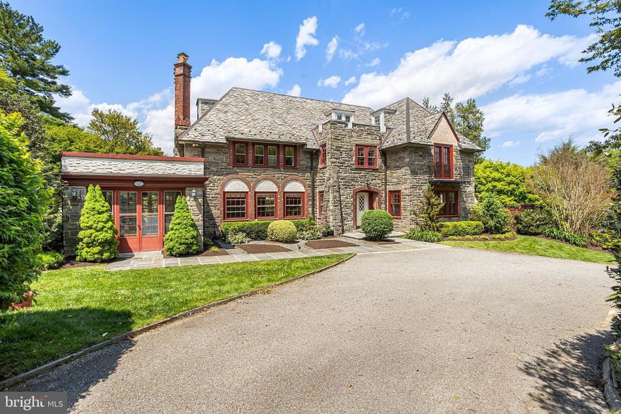Set on one of Bryn Mawr’s most picturesque streets, this quintessential Main Line residence blends timeless architecture with exceptional care and beautifully curated grounds. Wrapped in exquisite stonework and crowned by a classic slate roof, the Tudor home exudes warmth, character, and enduring elegance from the moment you arrive.
Inside, gracious living spaces are filled with natural light, rich architectural detail, and a seamless flow ideal for both everyday living and entertaining. Oversized windows frame beautiful views of the blooming grounds, while inviting interior spaces offer warmth, comfort, and timeless appeal.
Walk through the signature covered front door entry into a breathtaking reception hall, where a grand soaring staircase sets the tone for the timeless elegance found throughout the home. A formal living and dining space create a warm and welcoming flow ideal for both everyday living and entertaining, while a beautiful Mercer tile sun room bathed in natural light offers a peaceful space to enjoy morning coffee or relaxed evenings overlooking the beautifully landscaped grounds. A handsome office with custom built-ins offers the perfect work-from-home retreat.
The beautifully equipped eat-in kitchen blends timeless style with exceptional functionality, featuring a Sub-Zero refrigerator, beverage center, large center island with Viking cooktop, double wall ovens, Bosch dishwasher, two pantries, white cabinetry, and granite countertops. A powder room discreetly tucked beneath the staircase completes the first floor. 
Upstairs, the second floor hosts a luxurious primary suite with a marble bath. Beyond the bath, a private dressing room showcases incredible custom built-ins, generous closet space, and a desk area. Two additional bedrooms share a Jack-and-Jill bath, while a spacious rear room offers flexibility as a den, office, or lounge space. Also on this level are the laundry area, a playroom, and a nursery. A convenient rear staircase leads directly back to the kitchen. 
The third floor offers two additional bedrooms connected by a hall bath, along with an enormous cedar closet providing exceptional storage. 
The finished lower level expands the home’s versatility with a spacious family room, separate bedroom, full bath, and abundant storage — ideal for guests, an au pair suite, or extended family living.
In the spring and summer months, the property truly comes alive with lush, mature landscaping and vibrant gardens that create a storybook setting. Thoughtfully maintained and lovingly cared for, the home offers the rare combination of classic Main Line charm and true pride of ownership.
The home and grounds have been impeccably maintained allowing the next owner to move in with confidence. A rare opportunity to own an iconic Bryn Mawr property that captures the very essence of Main Line living — timeless, elegant, and beautifully cared for, all in a walkable neighborhood in award winning Lower Merion School District, minutes from shopping, dining, entertainment, and public transportation. This house is not to be missed!

Please note: Interior Photos will be added on Thursday. All square footage to be confirmed by buyer.