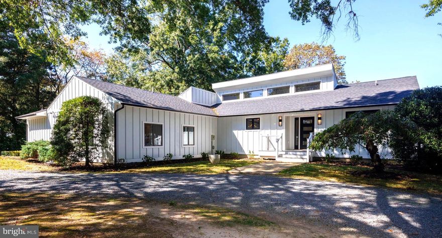 Welcome to "La Vue en Rose", a truly incredible coastal home  located in Oxford. MD. This very private property is sited on 2.2 acres with 180 degree panoramic westerly views overlooking Boone Creek - stunning sunsets! A surprise at every turn, this extraordinary one-story home has been thoughtfully and extensively renovated with no detail spared and the excellent craftsmanship is evident throughout. The open floor plan welcomes you from the moment you walk through the door and high ceilings, beautiful wood floors, and extraordinary water views can be seen from nearly every room. .Prepare culinary creations in the gourmet kitchen while entertaining guests in the open living room (with gas fireplace), expansive dining area, and adjacent glass-filled sunroom.. The large primary suite offers peaceful creek views, is accessible to the waterside deck and has an exquisite ensuite bath with soaking tub and large walk-in closet. Four other spacious  bedrooms (two with ensuite baths and two with a beautiful shared bath) encompass the living space and offer cozy quarters for friends and family. This stunning property is further complemented by a waterside swimming pool, private dock with two slips, 210' naturally protected shoreline, and new storage shed. The endless viewing of bald eagles, herons, and other wildlife is truly mesmerizing. This home exudes coastal chic, charm, and elegance!