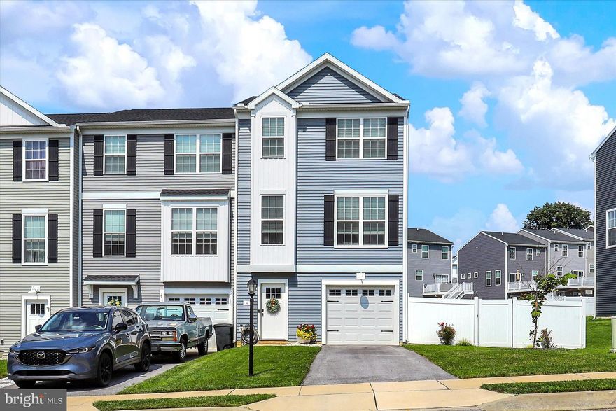 Welcome to this well-maintained, end-unit townhome built in 2021, located in a quiet yet convenient neighborhood in Hanover, PA. With 3 spacious bedrooms and 2.5 bathrooms, this home offers modern living with all the comfort and functionality today’s buyers are looking for. The main level features a bright, open-concept layout connecting the upgraded kitchen, dining area, and living room—perfect for entertaining or everyday living. Step out onto the private deck, which overlooks a fully fenced backyard—great for pets, kids, or relaxing evenings. Downstairs, enjoy the finished walk-out basement offering additional living space, perfect for a home office, playroom, or gym, along with a convenient half bath. Upstairs, you’ll find all three bedrooms, including a spacious primary suite with a walk-in closet and en-suite bathroom. The hallway also features a full bathroom and a dedicated laundry area for added convenience. Additional perks include an attached 1-car garage and driveway parking for two more vehicles. All just minutes from shopping, dining, schools, and everything Hanover has to offer. Don’t miss this turnkey opportunity—schedule your showing today!